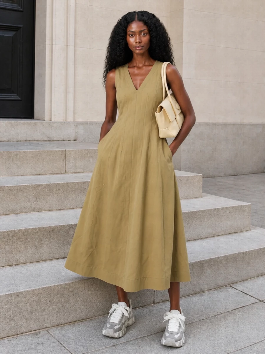 Pairing the sand Bottega midi with the sculpted Dolce&Gabbana sneakers creates a modern mix of soft tailoring and grounded sport that still feels distinctly quiet. The warm neutrals run from dress to sole, so the Tod’s buttercream top-handle just extends that calm, polished story. I chose the dress route instead of sweats and denim because it lets the chunky sneaker feel intentional and chic rather than purely casual.