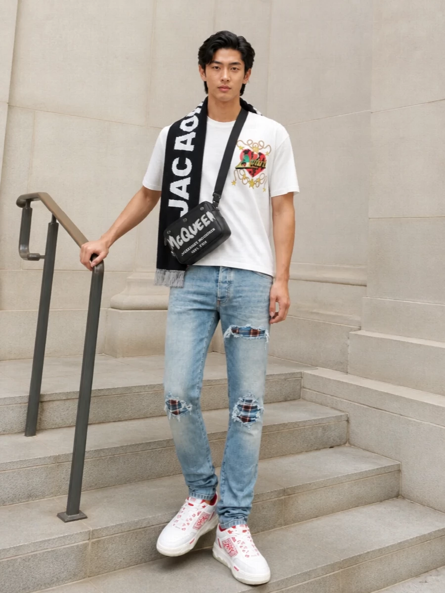 Amiri graphic tee ripped jeans red sneakers