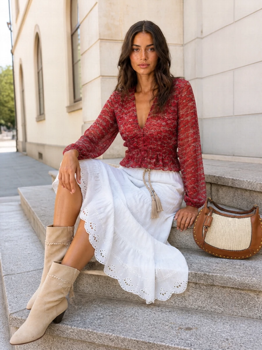 Romantic Isabel Marant at summer dusk, with the sheer crimson peplum skimming into a crisp, tiered white midi for light, balanced movement. Sand suede boots, a woven-lean hobo and a braided rope belt keep the palette sun-soft and bohemian while still polished enough for terrace dinners. The result is feminine, airy and leg-lengthening without ever feeling over-styled.