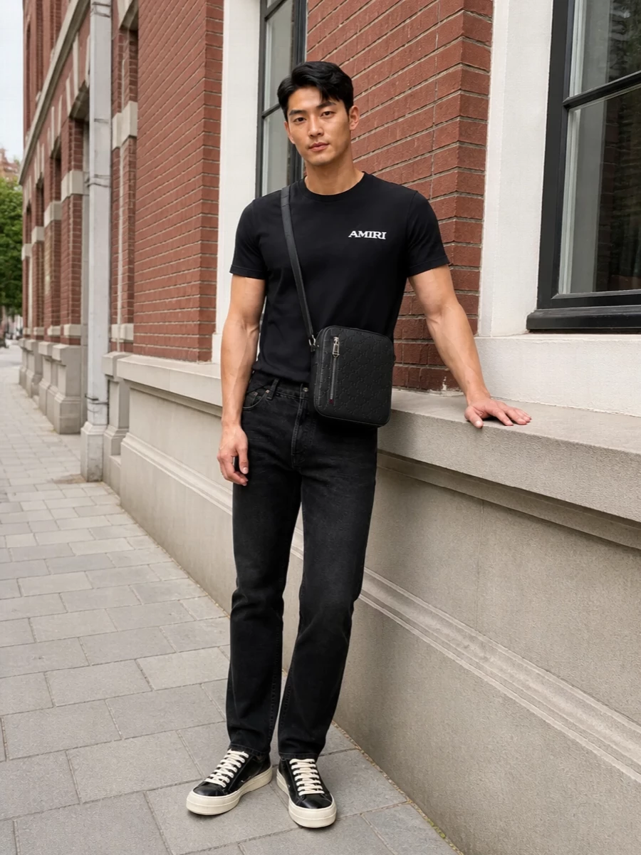 A black Amiri tee with washed-black Saint Laurent denim builds a tight monochrome story that feels quietly confident rather than loud. Rick Owens sneakers bring a slightly subversive sole and just enough contrast at the base. A compact Gucci crossbody finishes it with discreet designer weight that still feels easy for all-day city wear.