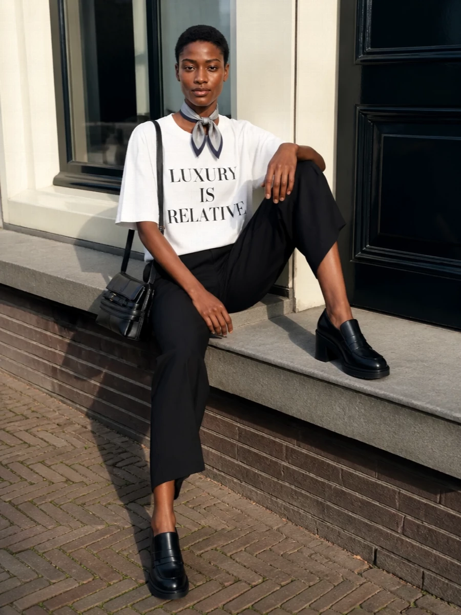Moschino slogan tee black wide leg pants outfit