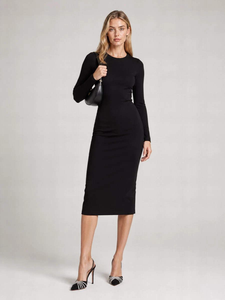 Anchoring the outfit with the long-sleeve black Dolce&Gabbana midi keeps the focus on pure line and proportion, which suits the sculptural Prada crescent bag’s minimalist, after-dark mood. The Aquazzura crystal slingbacks bring just enough light and height to sharpen the silhouette, keeping the overall feeling controlled, modern and quietly glamorous. Choosing the dress path over separates preserves a clean, uninterrupted column that lets the bag read as the single, deliberate statement at the shoulder.
