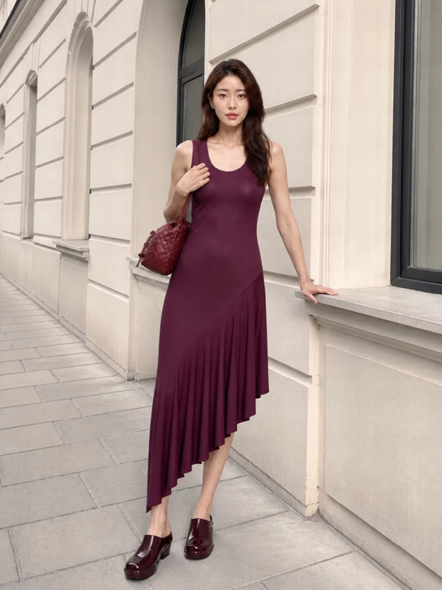 This is an evening-ready, plum-on-plum story that leans into sculptural lines and rich, saturated color. The Alaïa dress and Bottega mules share a fluid asymmetric movement and deep wine tone, reading modern yet controlled rather than overtly done. A compact burgundy Bottega shoulder bag keeps the focus on proportion and texture, staying within the quiet-luxury space while nodding to a slightly subversive, street-influenced attitude through the chunky mule.
