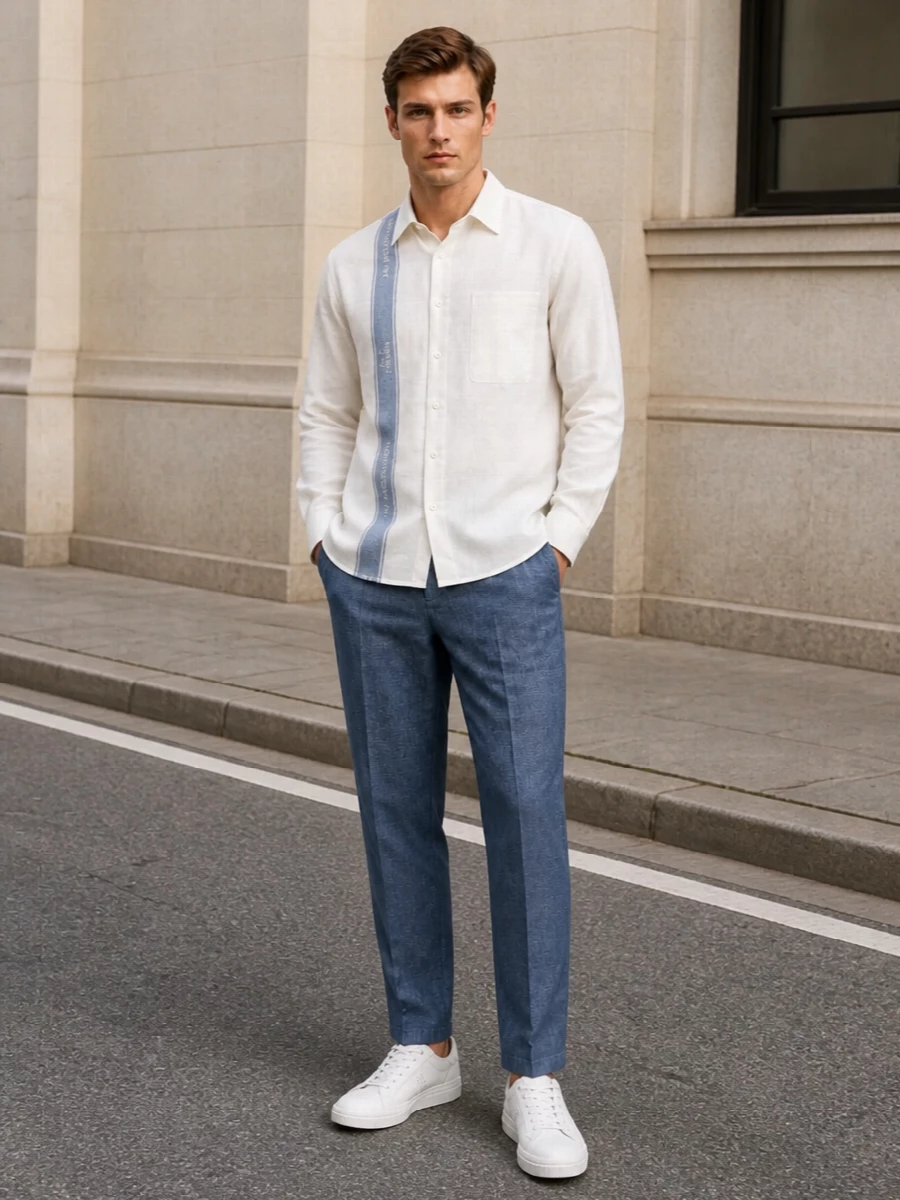 Chambray blue tailoring meets soft ivory and slate in a quietly precise mix of summer neutrals. The proportions stay clean and relaxed, with a light shirt and streamlined trouser grounded by crisp leather sneakers. A structured taupe tote finishes the story with just enough Fendi polish to feel intentional yet understated for warm city days and low-key evenings.
