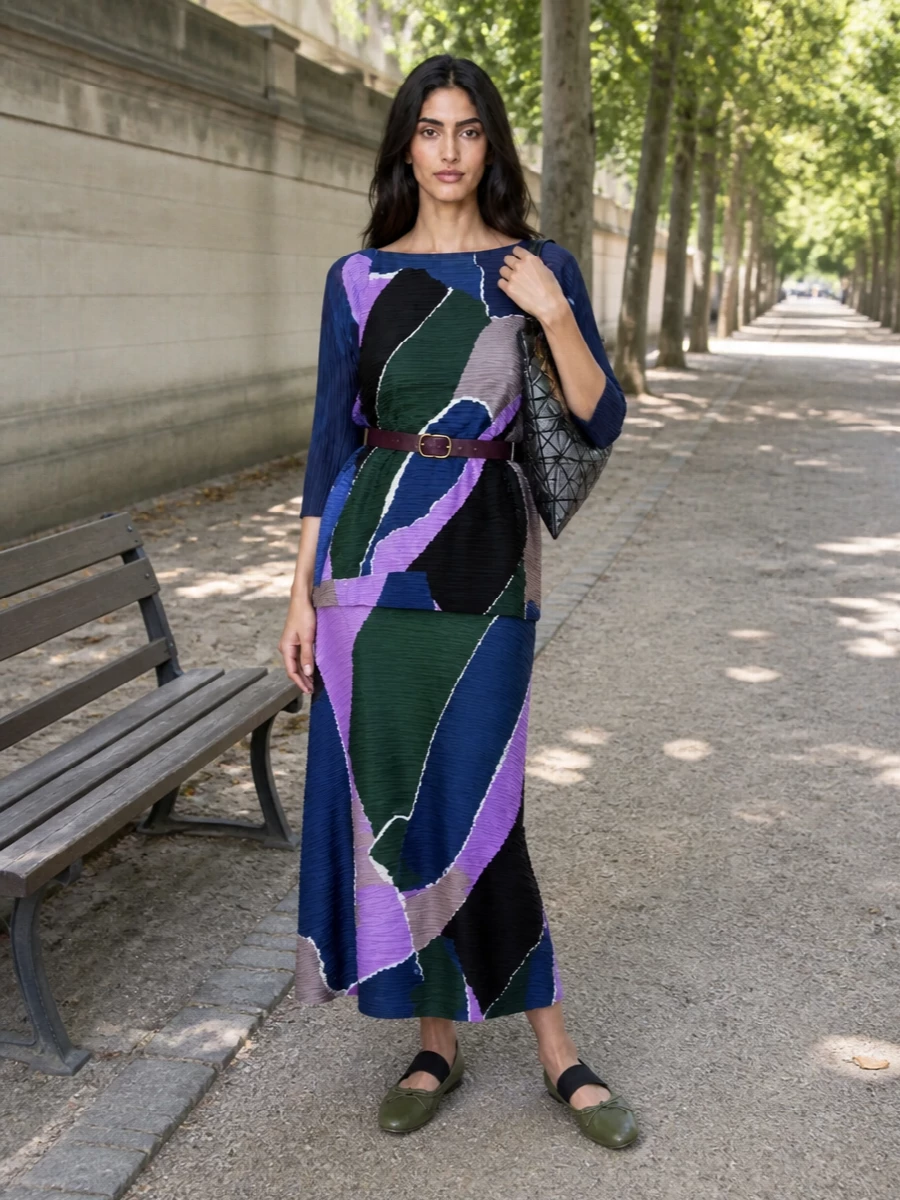 A full Pleats Please set turns the painterly pleats into a single, fluid column, then is grounded with olive MM6 ballerinas for a quietly directional city outfit. The Bao Bao tote brings a sculptural, graphic counterpoint, while the plum velvet belt just hints at waist definition without disturbing the movement of the pleats. It reads creative and polished, ideal for gallery days that stretch into dinner.
