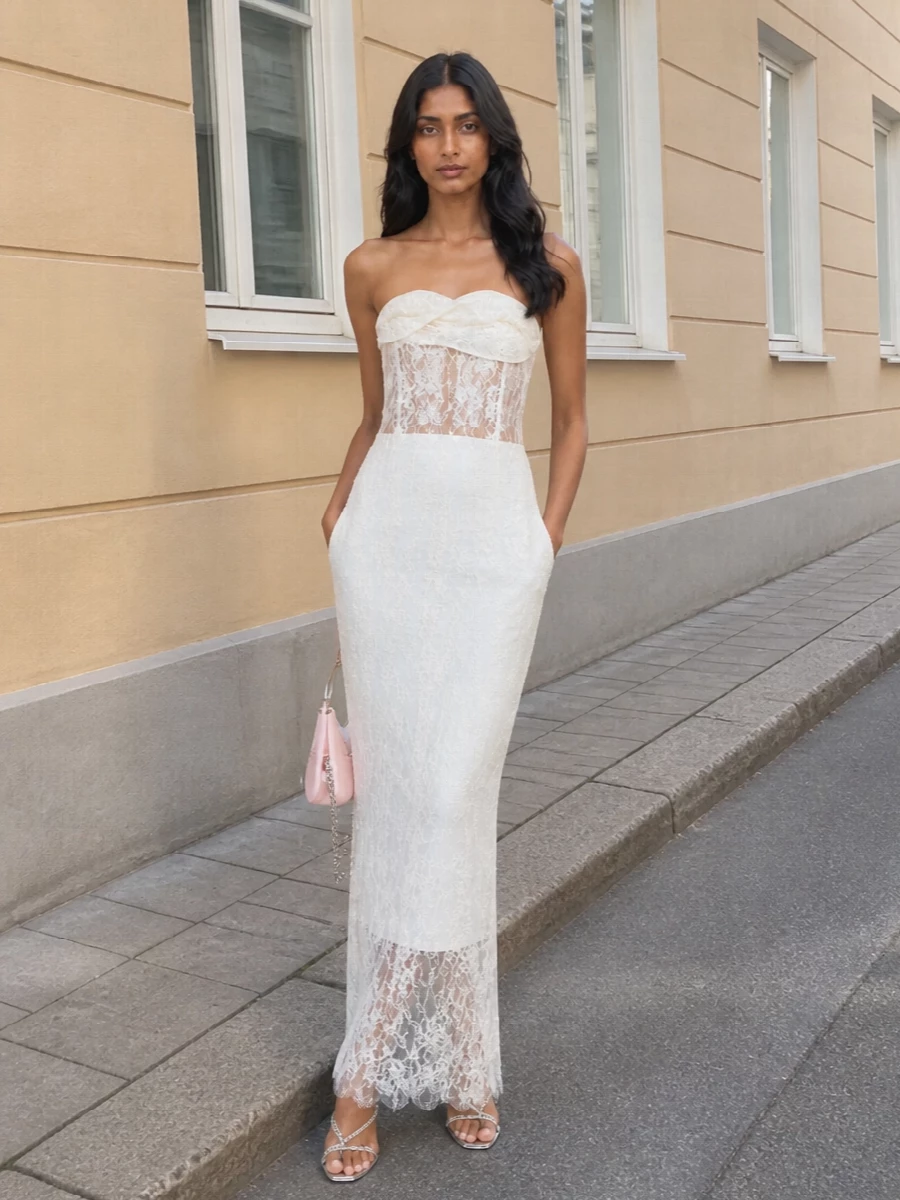 This pairing leans into a romantic, almost bridal summer mood, with the Magda Butrym lace column skimming the body and letting the mirrored Casadei sandals flash at the hem. The blush McQueen clutch adds a gentle hit of pastel and sleek metal, keeping the story soft, modern and quietly glamorous for high-formality evenings. I chose the dress path over separates here because the column silhouette and tonal lightness create a more seamless canvas for the sandals’ sparkle and feel more special-occasion ready.
