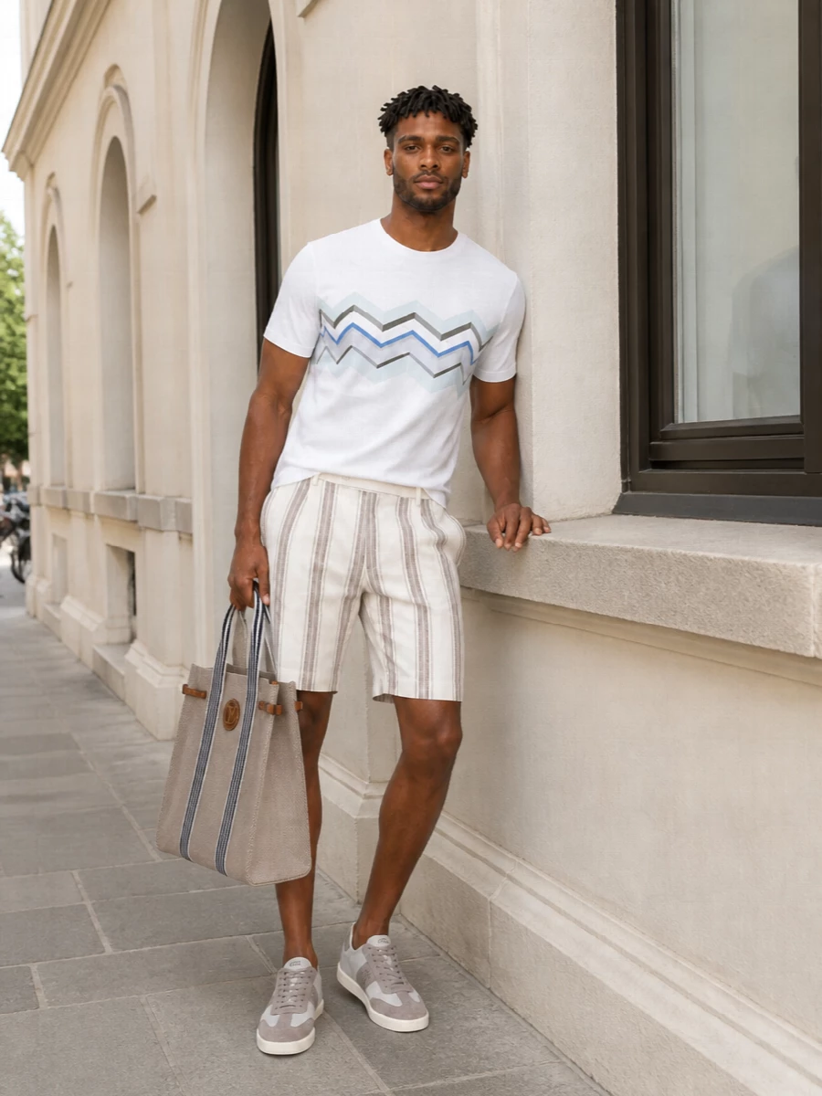 A crisp Missoni tee meets softly tailored striped shorts for a modern Riviera take on preppy dressing. Tonal grey Tod’s sneakers and a structured Valentino canvas tote keep the lines clean and the palette quietly nautical. It is relaxed enough for a seaside afternoon yet polished for terrace lunches in town.