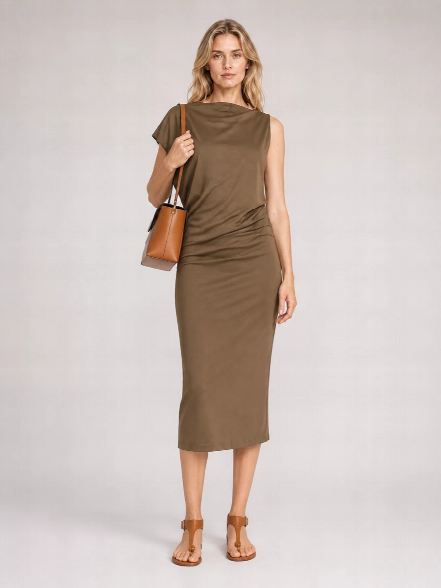 A taupe Jacquemus midi and tan Wandler shoulder bag come together in a quietly sculptural, monochromatic palette of warm browns. The fluid asymmetric dress keeps the line long and unfussy, while the slim tan sandals keep the mood relaxed but polished for warm days that drift into dinner. Choosing the dress route rather than separates lets the bag read as the focal point, with texture and tone doing the work instead of extra layers.