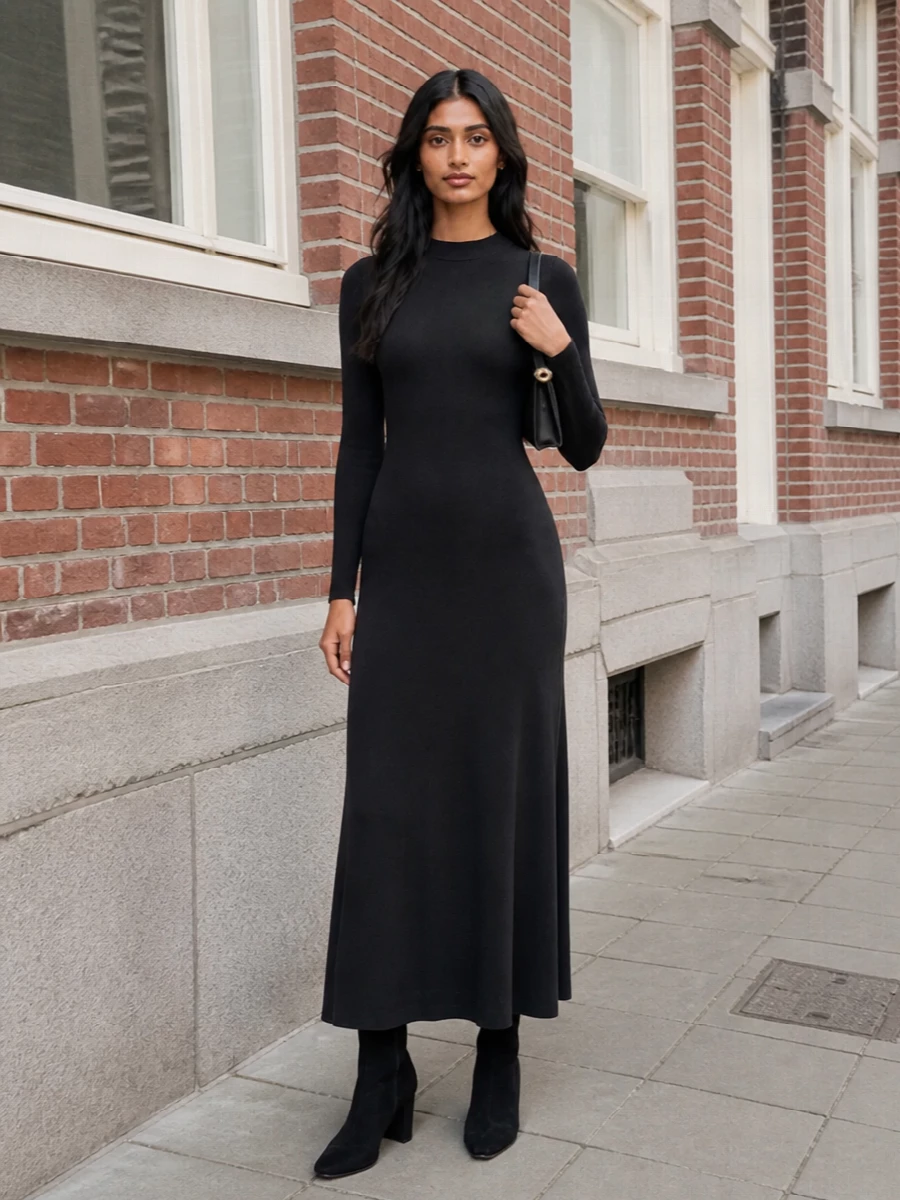 I’m anchoring this with the Tom Ford maxi rather than tailoring separates, because the boots want that uninterrupted black column and a truly evening-level calm. The result is a clean, high-neck silhouette that reads powerful but discreet, with the suede ankle boots sharpening the line and the sculptural clutch adding just enough metal to catch the light. It is a quietly luxurious all-black ensemble that can slip into any serious dinner or event without ever feeling overworked.