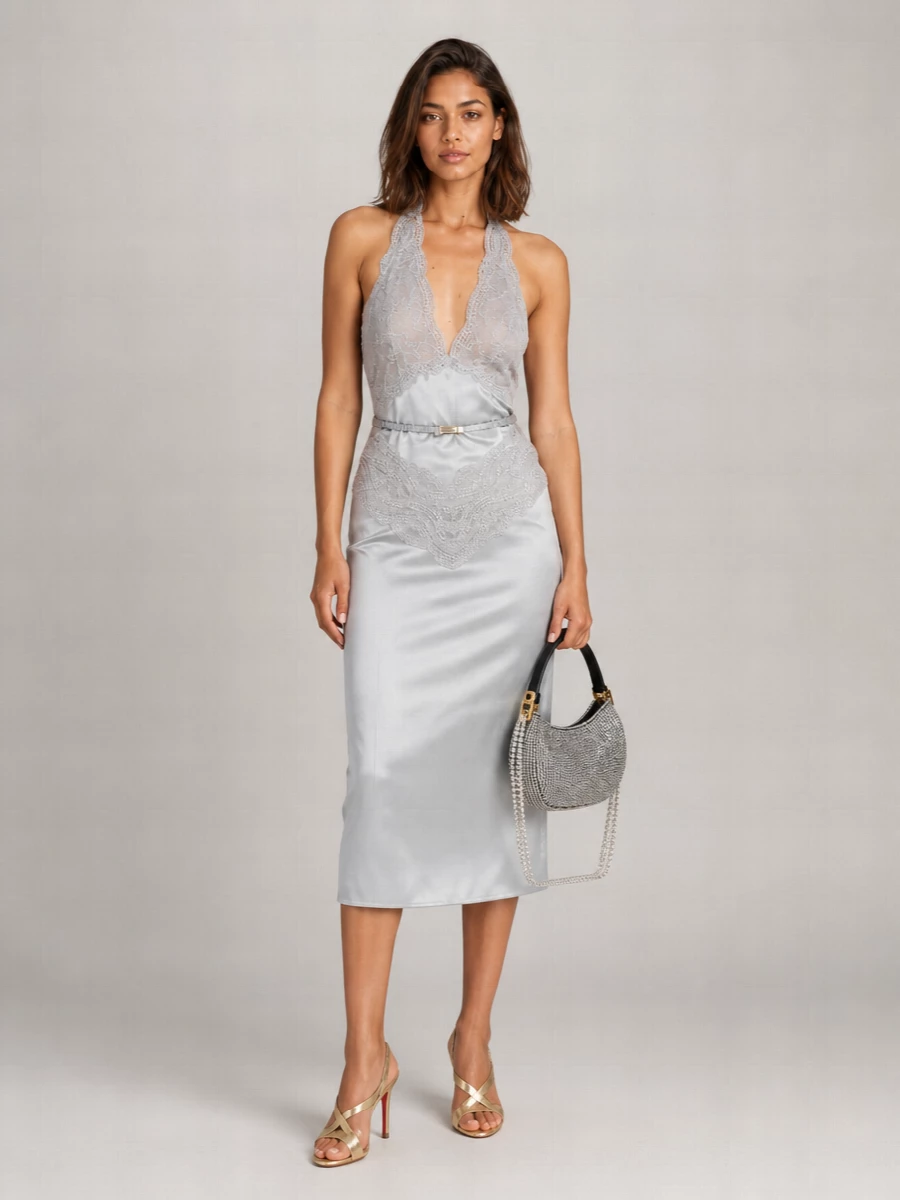 Silver satin, lace and glinting metallic accessories create a quietly opulent cocktail ensemble that feels like pooled moonlight. The Louboutin mules keep the silhouette light and elongated, while the beaded Magda Butrym mini bag adds a romantic, jewelry-like sparkle in your hand. It is a refined evening statement for winter events where you want softness, shine and precision in equal measure.