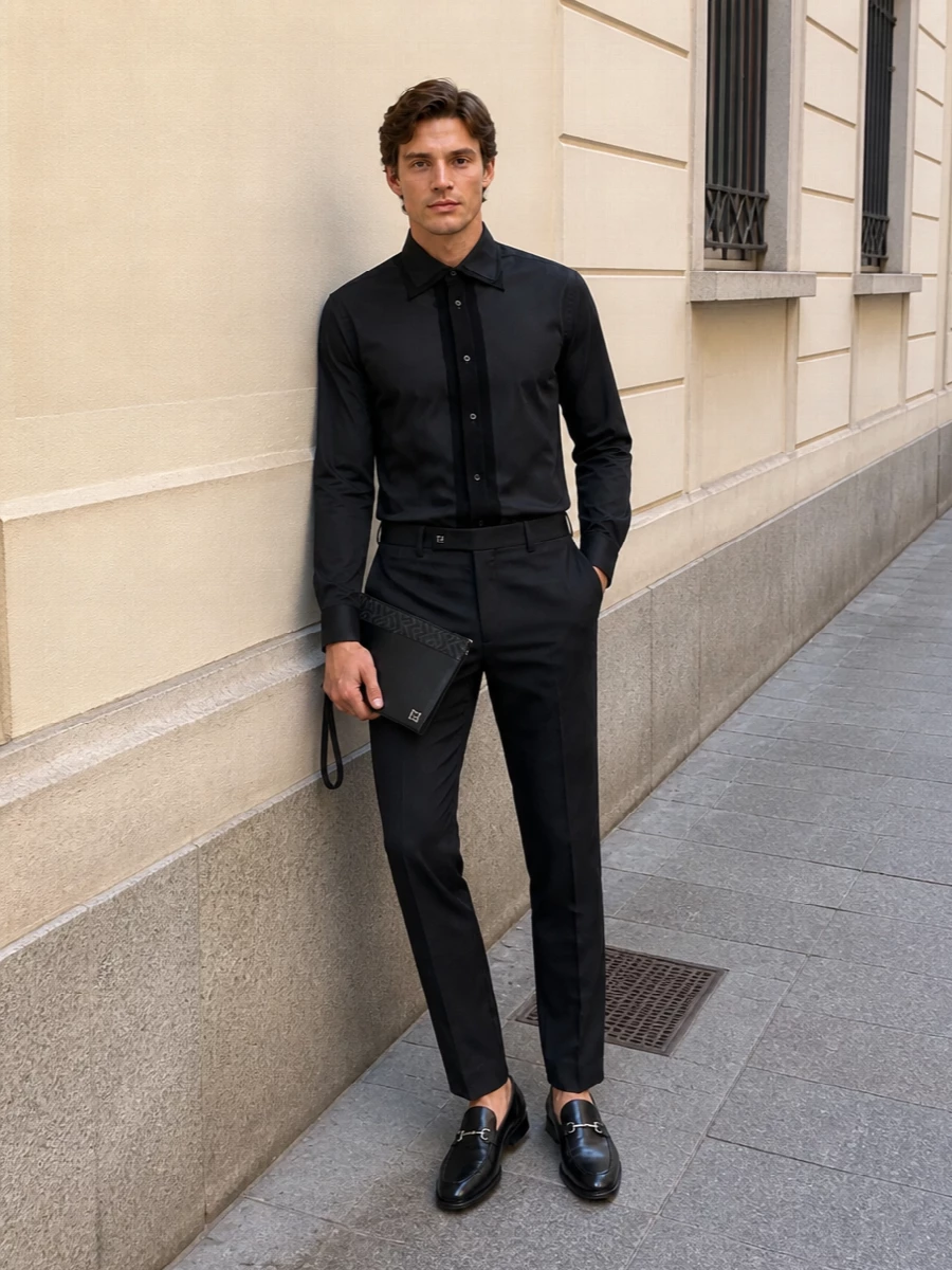 A deep, tonal take on evening tailoring that keeps everything in the black and charcoal family so the Gucci horsebit loafers feel intentional rather than an afterthought. The Margiela shirt and Fendi trouser sharpen the line without stiffness, so the result reads quietly powerful from late client dinner to night bar. The Fendi clutch finishes it with a controlled hit of logo that matches the silver hardware on the shoes.