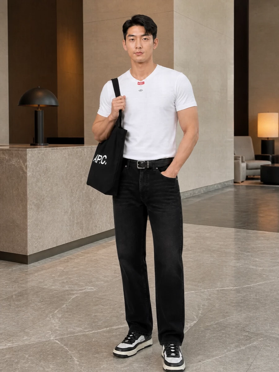 A crisp white Diesel tee sits against washed black straight-leg denim for a monochrome base that feels easy but sharp. Charcoal and white sneakers keep the energy sporty, while a black A.P.C. tote and a clean Diesel belt add just enough structure to make this an all-day city uniform. The result is low-key Diesel streetwear that reads considered without trying hard.