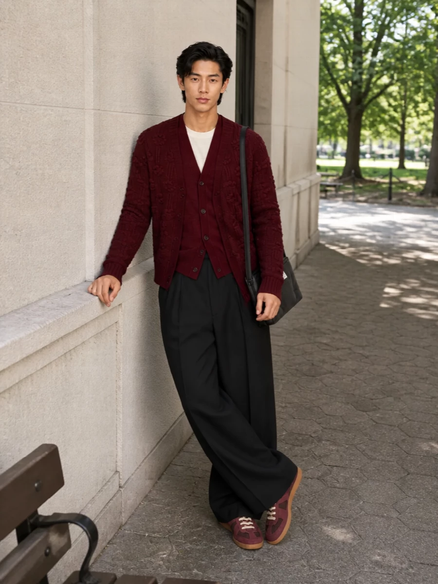 Deep burgundy layers with inky black tailoring for a knit-heavy city uniform that feels considered without tipping into fuss. The wide-leg trouser offsets the cropped cardigan, while tonal sneakers and a padded crossbody keep everything grounded in modern, art-school street polish.