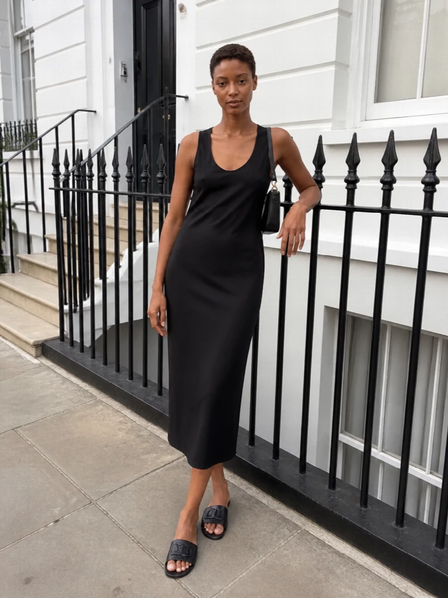 A black midi slip and sleek logo slides create a low-key, monochrome column that feels refined without trying. The flat profile keeps it grounded and walkable for real city days. Choosing the dress path lets the sandals sit in their element, framing them as a deliberate, minimalist choice rather than just a casual finish to separates.