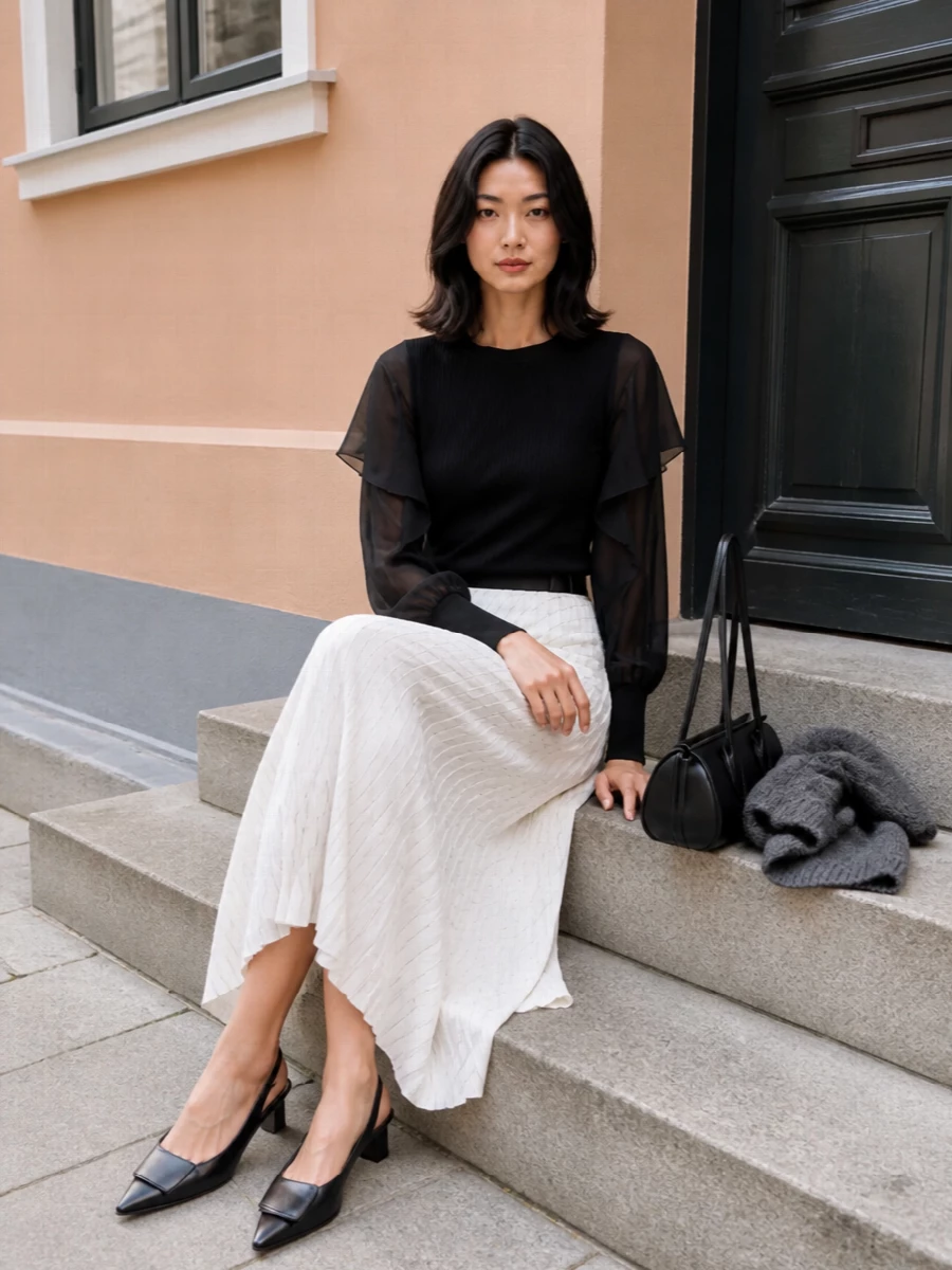 Sacai black knit top ivory pleated skirt outfit