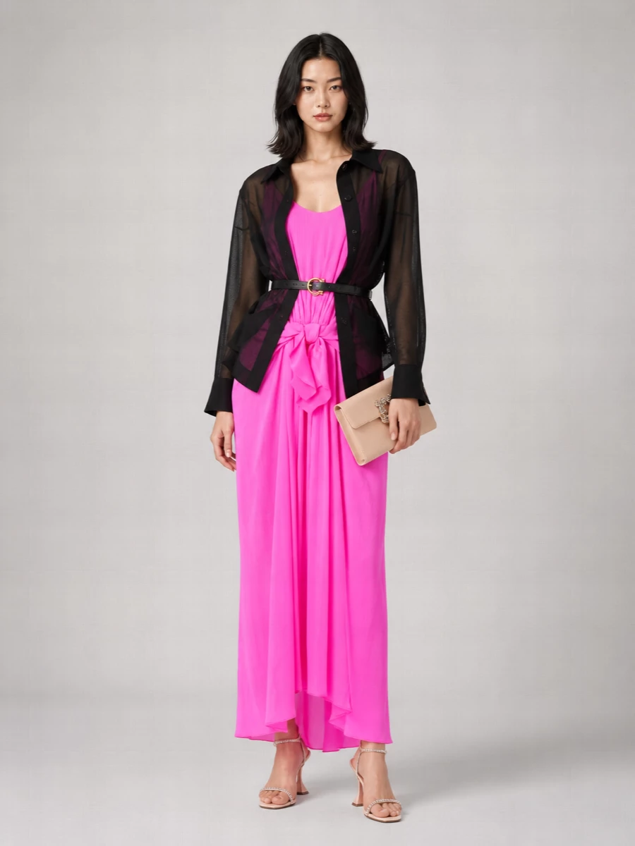 A neon pink column is softened with blush and nude crystal accents so the color feels intentional rather than loud. The slim, draped silhouette stays clean from head to toe, with barely-there heels and a refined satin clutch echoing the dress’s movement. It is modern cocktail dressing that reads bold yet quietly luxurious in person and in photographs.