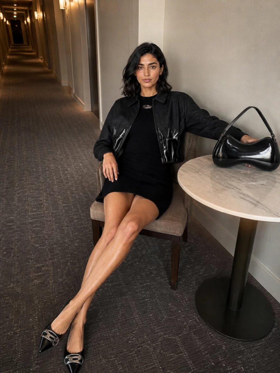 I’m anchoring this with a dress rather than top and skirt or trousers so the jacket can do the sculpting and the rest of the outfit reads as one long, clean column. The ribbed mini, pointed flats and glossy shoulder bag all talk to the jacket’s tailored-meets-club mood, keeping everything monochrome, high-shine and sharply nocturnal. It is a compact, high-impact Diesel night outfit that moves easily from bar to late club without ever feeling overworked.
