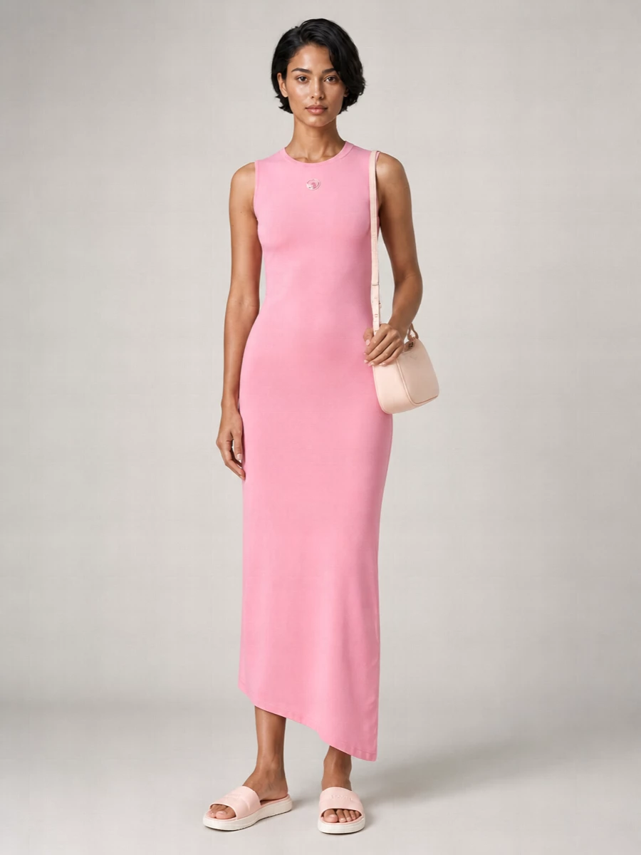 A soft pink Marine Serre column dress teams with blush Moncler slides for a clean, sport-leaning take on summer femininity. The slim baguette in powdery blush keeps everything tonal and minimal, so the colour story stays quiet while the silhouette feels relaxed and modern. Choosing the dress route over separates keeps the outfit streamlined and lets the slides read intentional rather than purely casual.