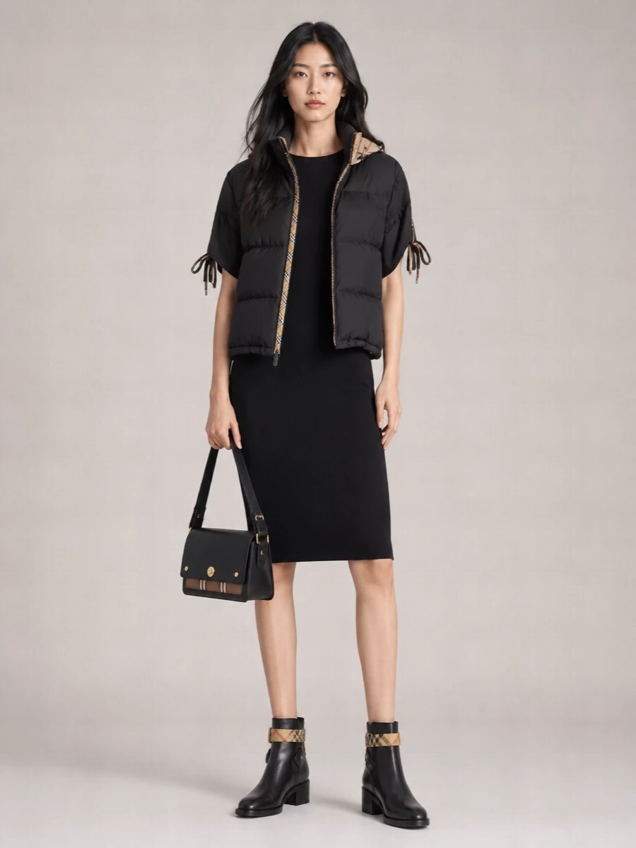 I’m styling the puffer with a single anchor piece, so I’ve skipped separates and gone for the Burberry ribbed T-shirt dress as the base. It keeps the check story subtle and focused, letting the jacket’s placket and the boot straps do the talking while the all-black column feels sleek, urban and winter-ready. Block-heel ankle boots and a structured black shoulder bag finish it with just enough polish to move from daytime errands to low-key dinners without losing that streetwear edge.