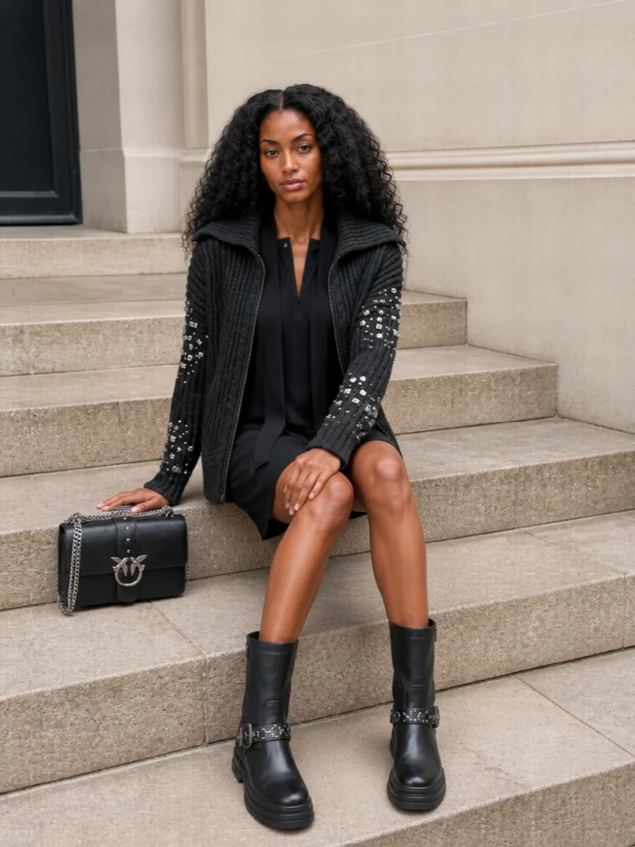 I chose the dress route, because layering the crystal-collared knits under this heavily embellished ribbed jacket would feel fussy, while a sharp mini shift keeps the sparkle focused and intentional. The embellished shift, chunky logo boots and structured silver-hardware bag create a city-night uniform that is strong, sleek and winter-ready around the statement Pinko jacket. The result is rock-tinged quiet glamour that moves easily from dinner to late drinks without losing comfort or attitude.
