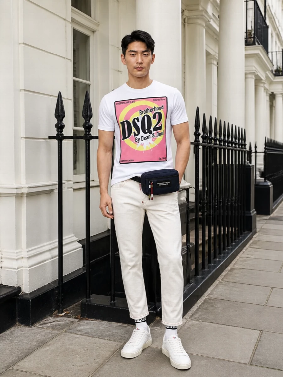 A graphic Dsquared2 tee sits on crisp off-white denim for a clean, high-contrast take on casual streetwear. Off-white sneakers and matching striped socks keep the palette tight and light, while a navy belt bag adds just enough utility edge for city days. The result is bold from the back, pared back from the front, and easy to wear all warm season long.