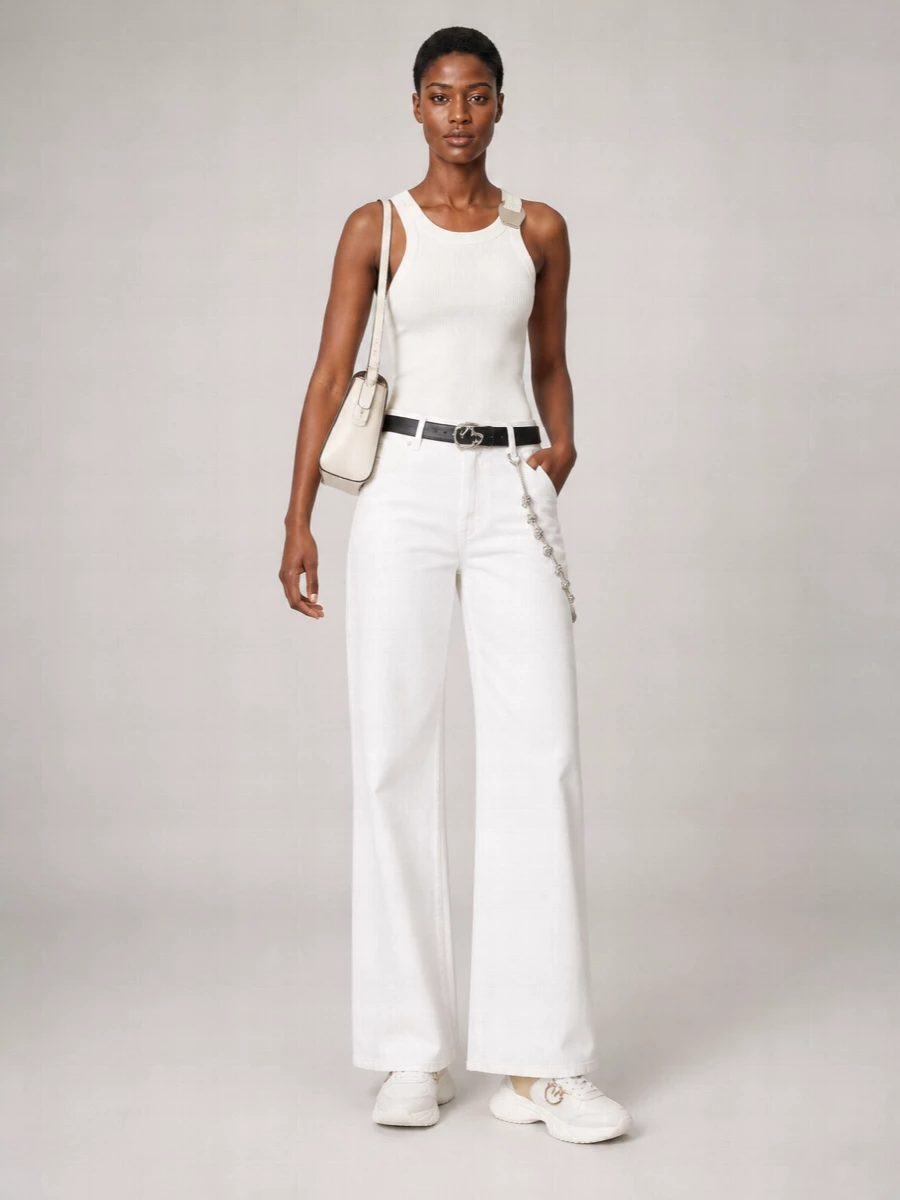 A soft white ribbed tank meets wide-leg white trousers for a tonal, city-ready take on streetwear that feels clean rather than sporty. Chunky neutral sneakers keep it grounded and practical, while the ivory shoulder bag and slim silver-detailed belt echo the metal hardware and pull the palette together. The result is light, modern and easy to wear from morning errands to late coffee dates with nothing more than a jewelry switch.