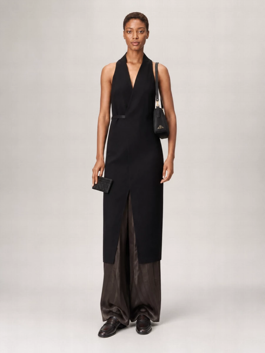 I’m anchoring this with the Rick Owens halterneck dress rather than tailoring it as top and trouser, because its strong vertical line and precise belt speak directly to the Bottega cardholder’s structured quietness. Dark Dries loafers keep the energy grounded and modern, while the Prada shoulder bag adds a discreet, logoed note that reads luxurious without shouting. Together it feels like a sharp, urban evening uniform for someone who prefers architecture over ornament.