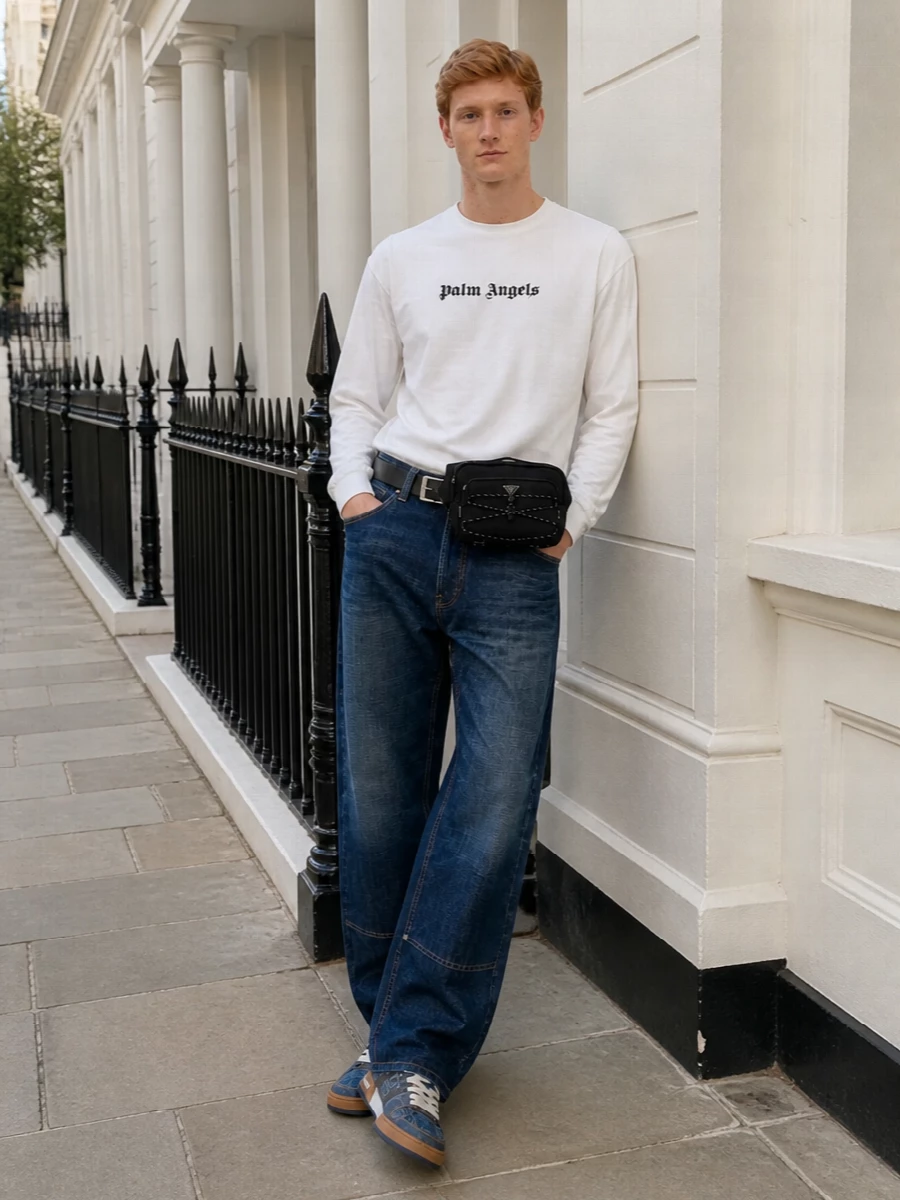Palm Angels denim meets clean skate energy: dark indigo jeans grounded with an off white logo long-sleeve and denim-accented Fendi sneakers for a tight, blue-toned story. The Prada belt bag and belt keep everything functional and graphic, giving the outfit a polished street utility finish without overcrowding the silhouette.