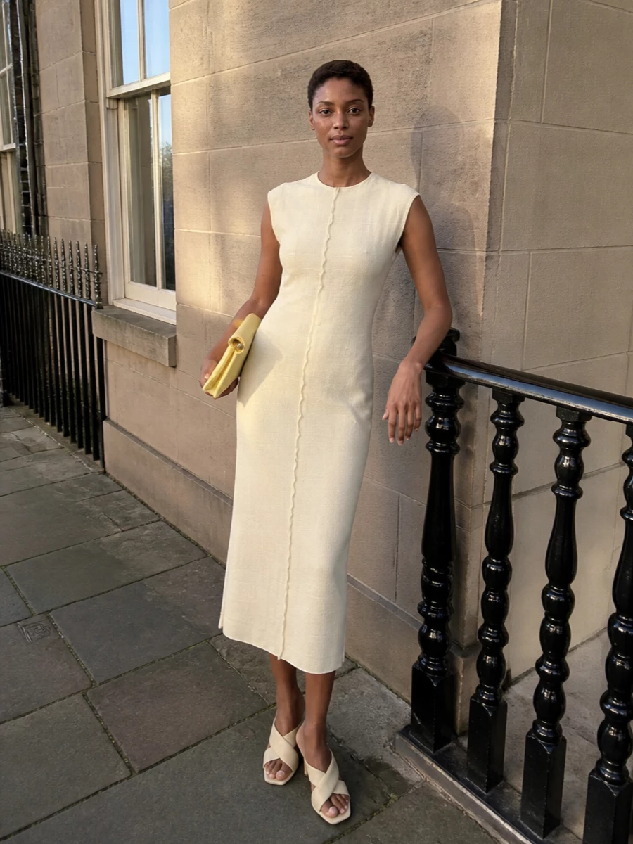 I’m anchoring this with the buttercream Ami Paris sheath rather than a top and mini, so the Jacquemus bag reads as a soft hit of color against a calm, sculpted base. The clean midi line, pale neutral tone and barely-there Bottega mule keep the outfit minimalist and quietly luxurious, ideal for dinners or gallery evenings where you want polish without drama. Lemon and buttercream sit close on the spectrum, so the bag feels intentional, not matchy, within this muted, tonal story.