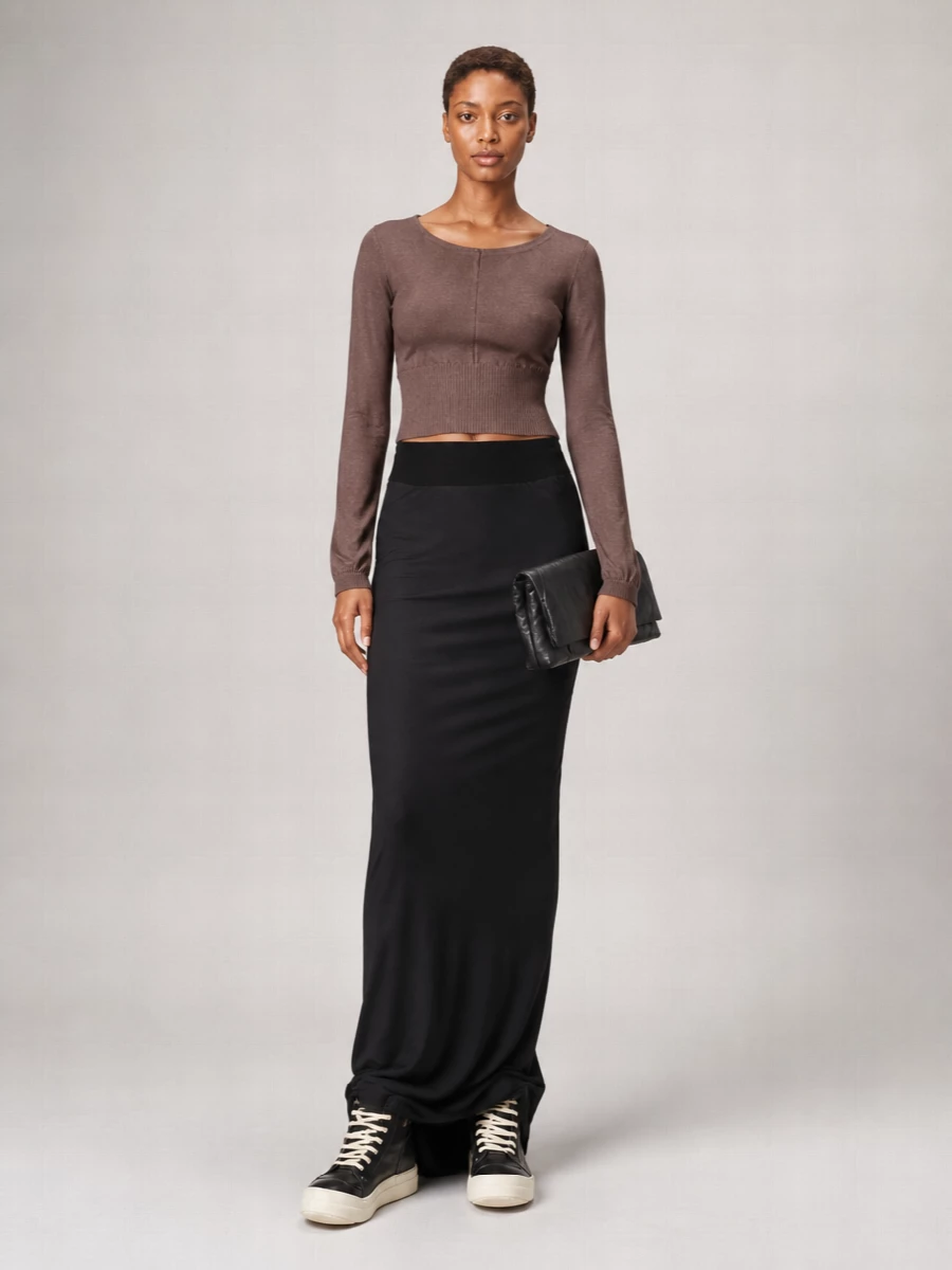 Mocha and black are treated as neutrals here, building a long, column silhouette that feels quietly strict yet relaxed enough for city days. The cropped knit and high-waisted jersey skirt meet right at the ribcage, so all the interest sits in proportion and texture rather than print. High-top sneakers and a soft clutch keep it grounded in Rick’s street-driven minimalism while still reading polished enough for late afternoons that stretch into night.