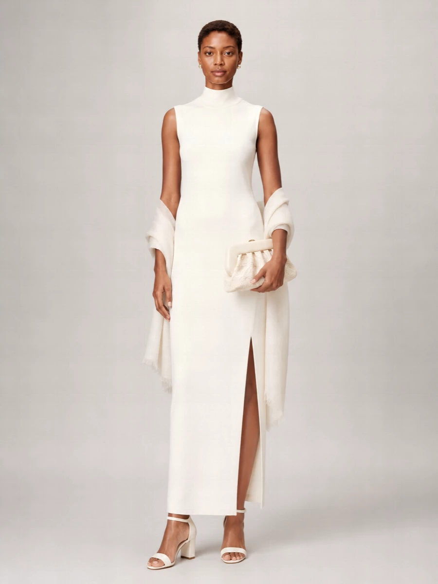 An ivory-on-ivory story keeps the Solace London column dress feeling serene and modern, with the block-heel sandals and framed clutch echoing its clean, architectural lines. Small pearl studs and a whisper-light wrap add just enough softness for a wedding or gallery dinner without breaking the minimalist spell.