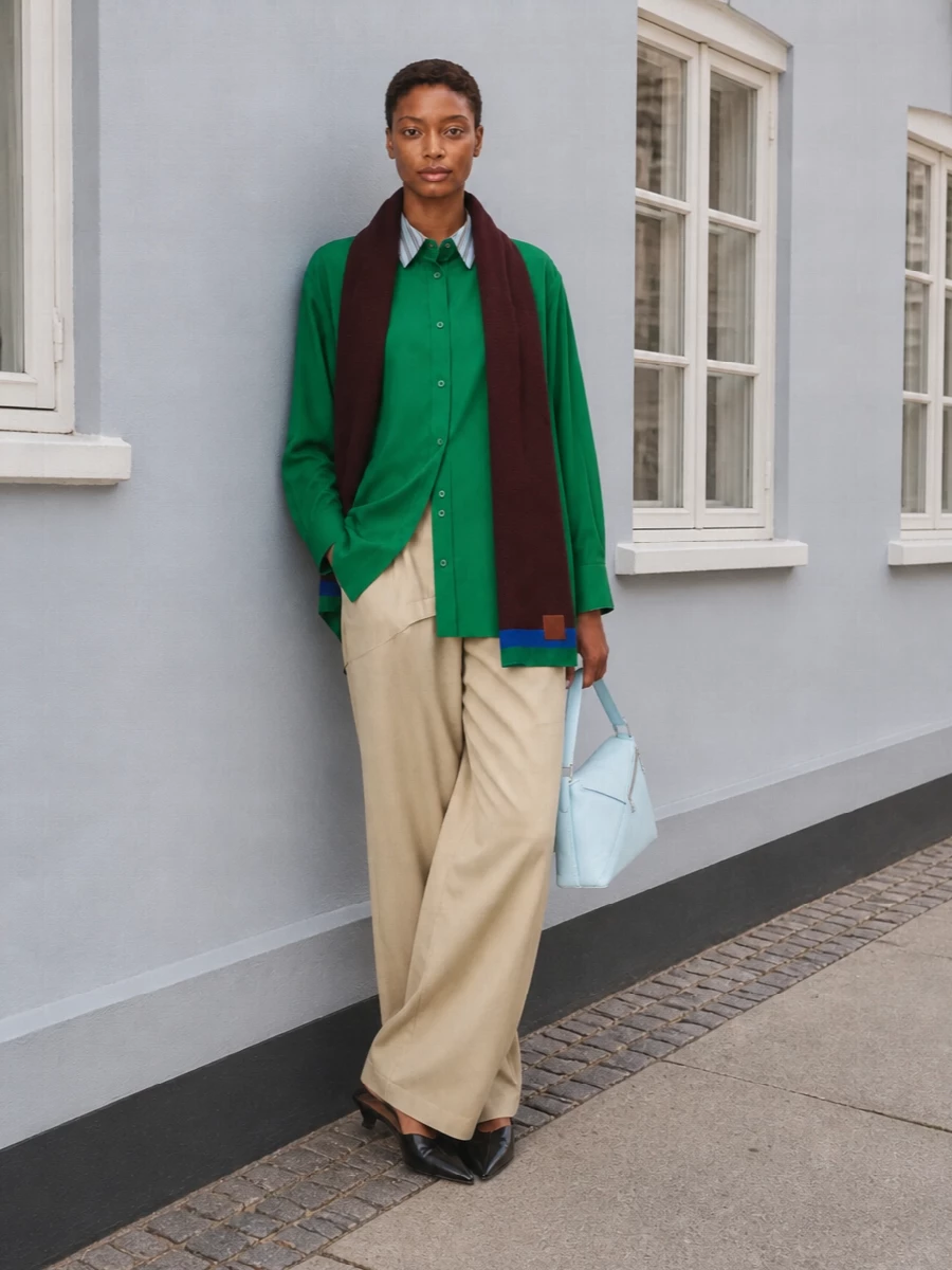 Loewe green shirt wide beige trousers outfit