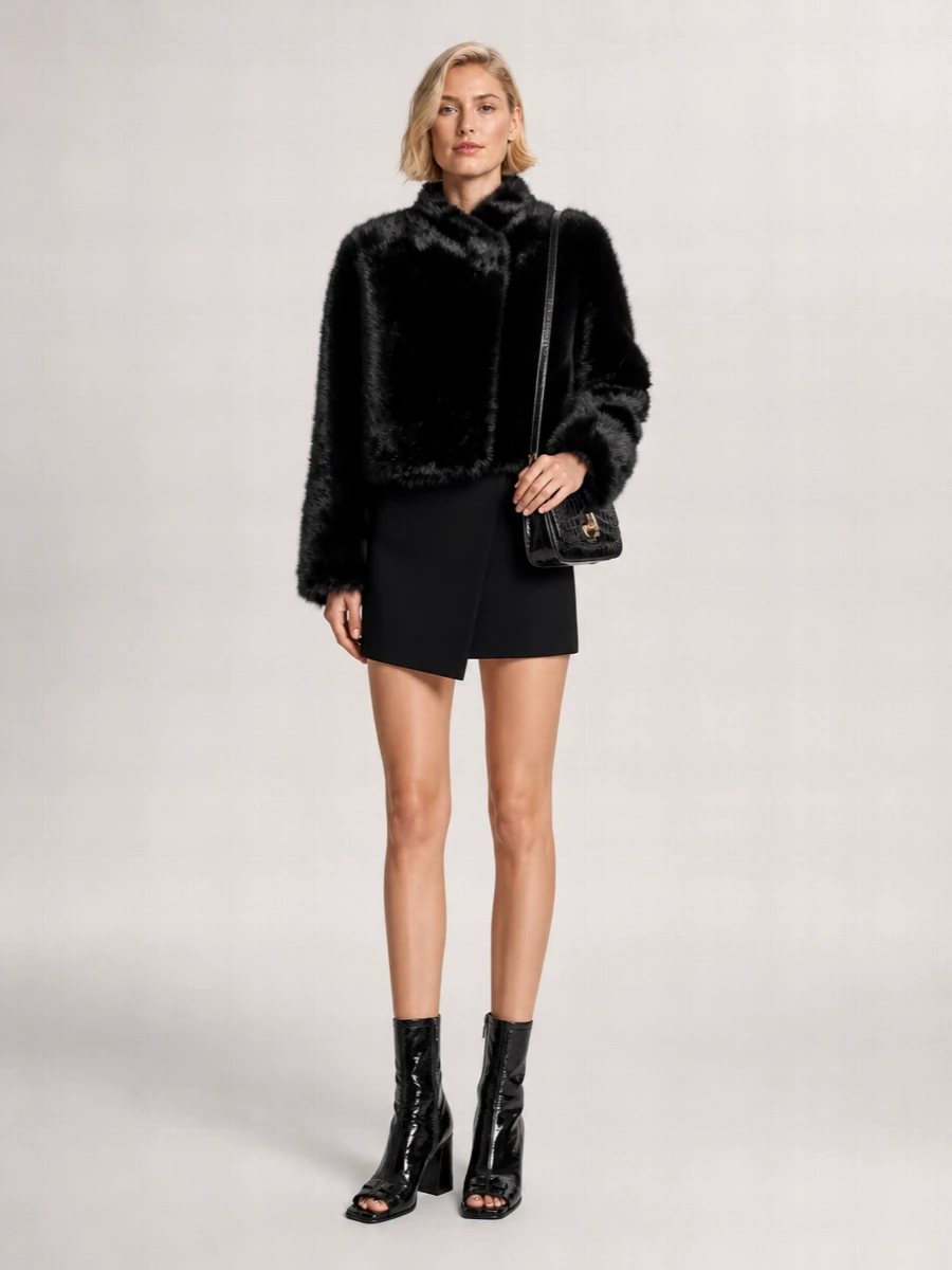 I’m taking the dress route so the tux-inspired Coperni mini can act as a clean, sculpted anchor under the cropped faux-fur jacket instead of fighting a separate top and bottom. Glossy Courrèges ankle boots and the Patou croc shoulder bag extend the dark, high-shine story, keeping everything leggy and precise while the fur delivers the drama. The result is a tight, city-night uniform that feels directional but still very wearable from dinner straight to the club.