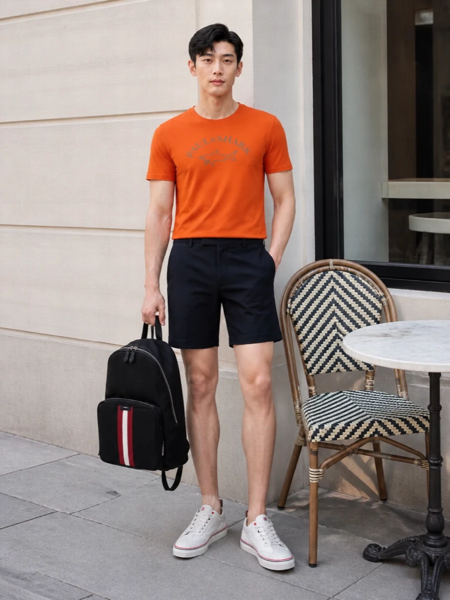 Bright and upbeat, the orange Paul & Shark tee sits against sharp navy tailored shorts for a clean, preppy take on sport. White Thom Browne sneakers keep everything fresh and streamlined, while the structured Bally backpack brings a practical, city-ready finish. It is an easy uniform for seaside weekends or relaxed urban days when you still want to look considered.