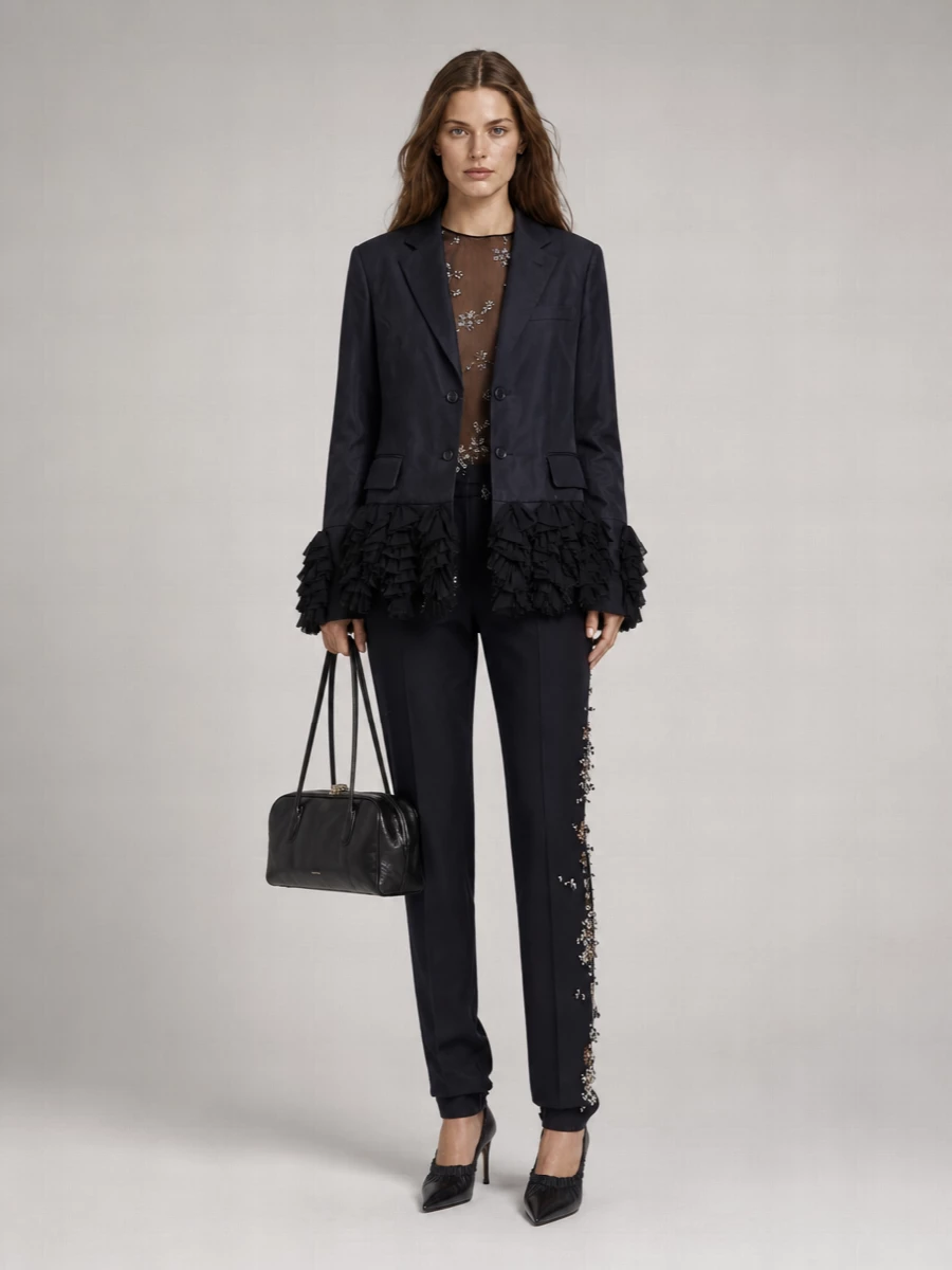I am building this around tailoring rather than a dress, because the Comme des Garçons blazer deserves to sit within a sculpted trouser story where its tulle hem can really read as the disruption. The sheer metallic blouse and embellished Dries trouser keep everything in an ink-black, navy, silver conversation, so the drama is in cut and surface, not random color. Pointed Gucci pumps and a disciplined Jil Sander bag finish it as a razor-sharp evening suiting ensemble that feels romantic, intelligent and unmistakably designer-tier.