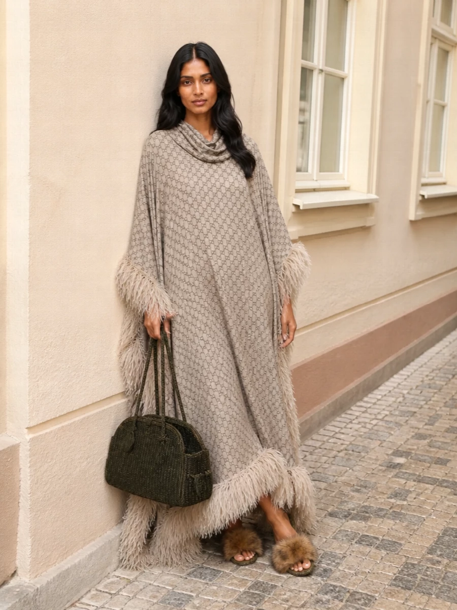 Gucci’s cocooning poncho dress meets plush Dolce&Gabbana slides and an artisanal Jacquemus tote for a quietly hedonistic resort story. Neutrals stay warm and sun-faded, while texture does all the talking. It drifts easily from poolside chaise to sunset drinks without ever feeling over-styled.
