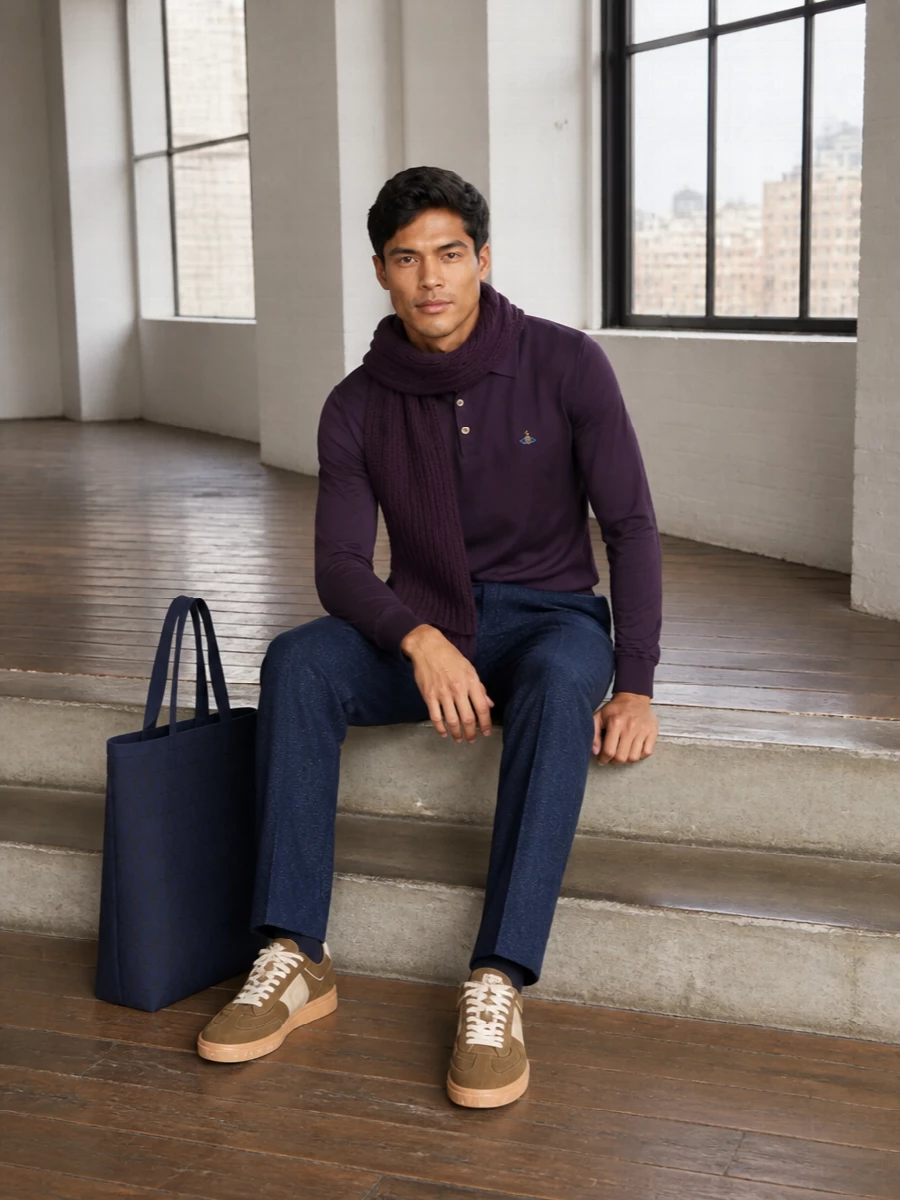 Deep aubergine and midnight blue set a moody, refined base that feels right for city days where you want polish without formality. Straight, tailored lines on both top and trouser keep the silhouette clean, while the warm taupe sneaker and navy tote soften the edge and make the outfit feel lived-in rather than strict. The plum scarf ties the tones together, giving a subtle, tonal play that rewards a second glance.