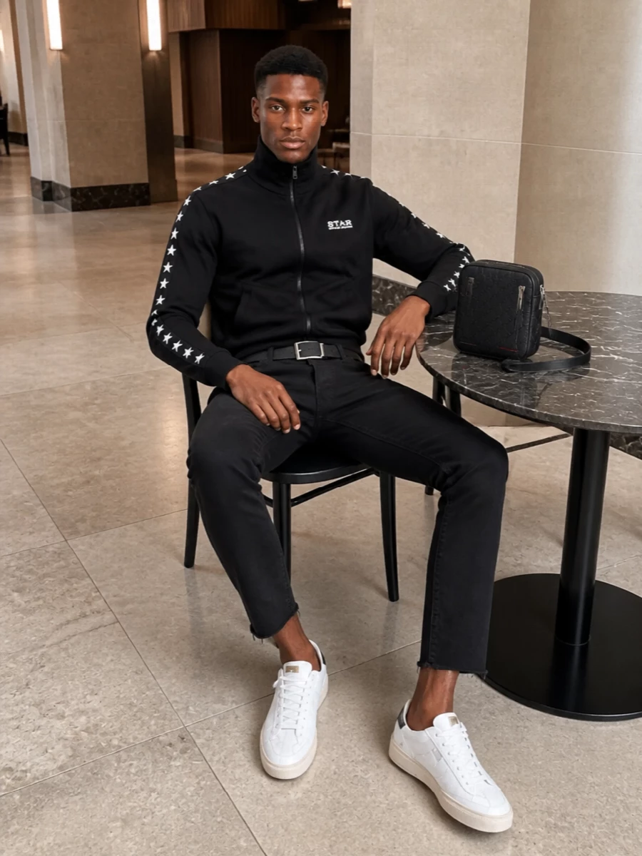 Golden Goose’s star-trimmed track top sits against sharp, faded-black cropped denim for a clean, athletic street feel. Off-white sneakers and a black leather belt keep the palette tight, while a compact Gucci crossbody adds just enough polish without breaking the sporty attitude.