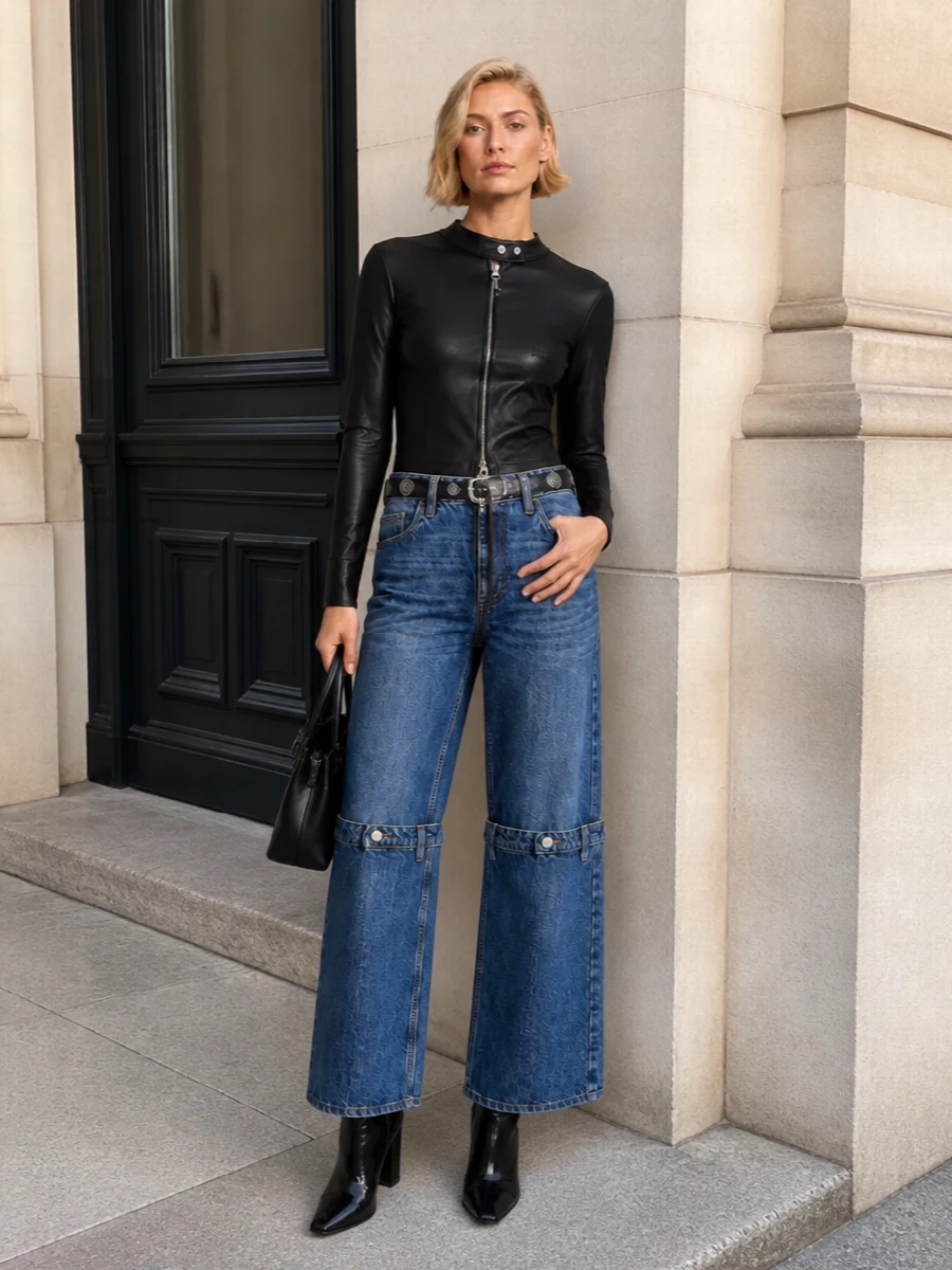 A directional Coperni jean meets a slick, zipped Courrèges top for a hard-edged, night-city take on denim-on-denim. Glossy space-age boots and a sculptural black bag keep everything streamlined, while a studded belt injects just enough attitude into the wide-leg silhouette. The result is a graphic, hardware-driven outfit that moves easily from gallery openings to late bars.