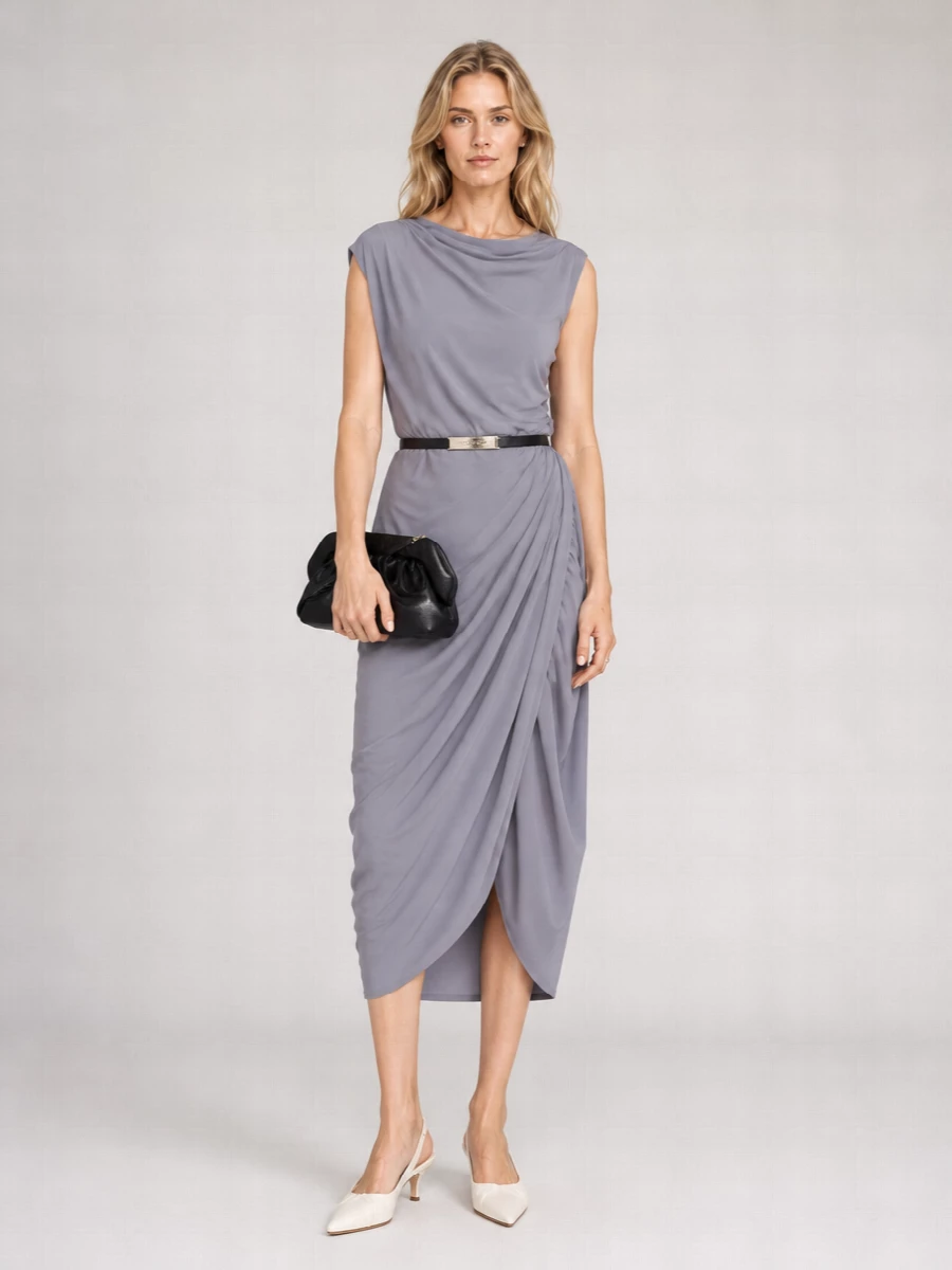 Slate lilac draping stays centre stage, framed by ivory slingbacks and a glossy black clutch that keep the palette calm and modern. A single gold ring and optional slim belt add just enough definition and light, preserving the dress’s sculpted ease for evening. The result feels composed, feminine and quietly confident for dinners or gallery nights.
