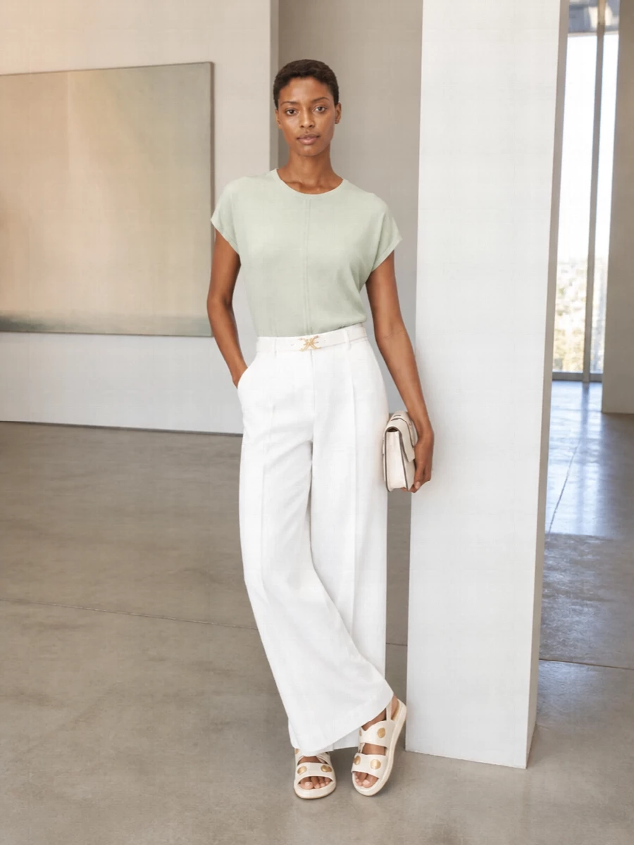 Soft sage and clean white keep this outfit quietly refined, perfect for warm days when you still want to feel put together. The wide-leg trouser and drapey tee create an easy long line, while cream accessories and subtle gold hardware add just enough polish for coffee meetings, gallery visits or a relaxed office day. It is understated, tonal and modern, with comfort built into every piece.