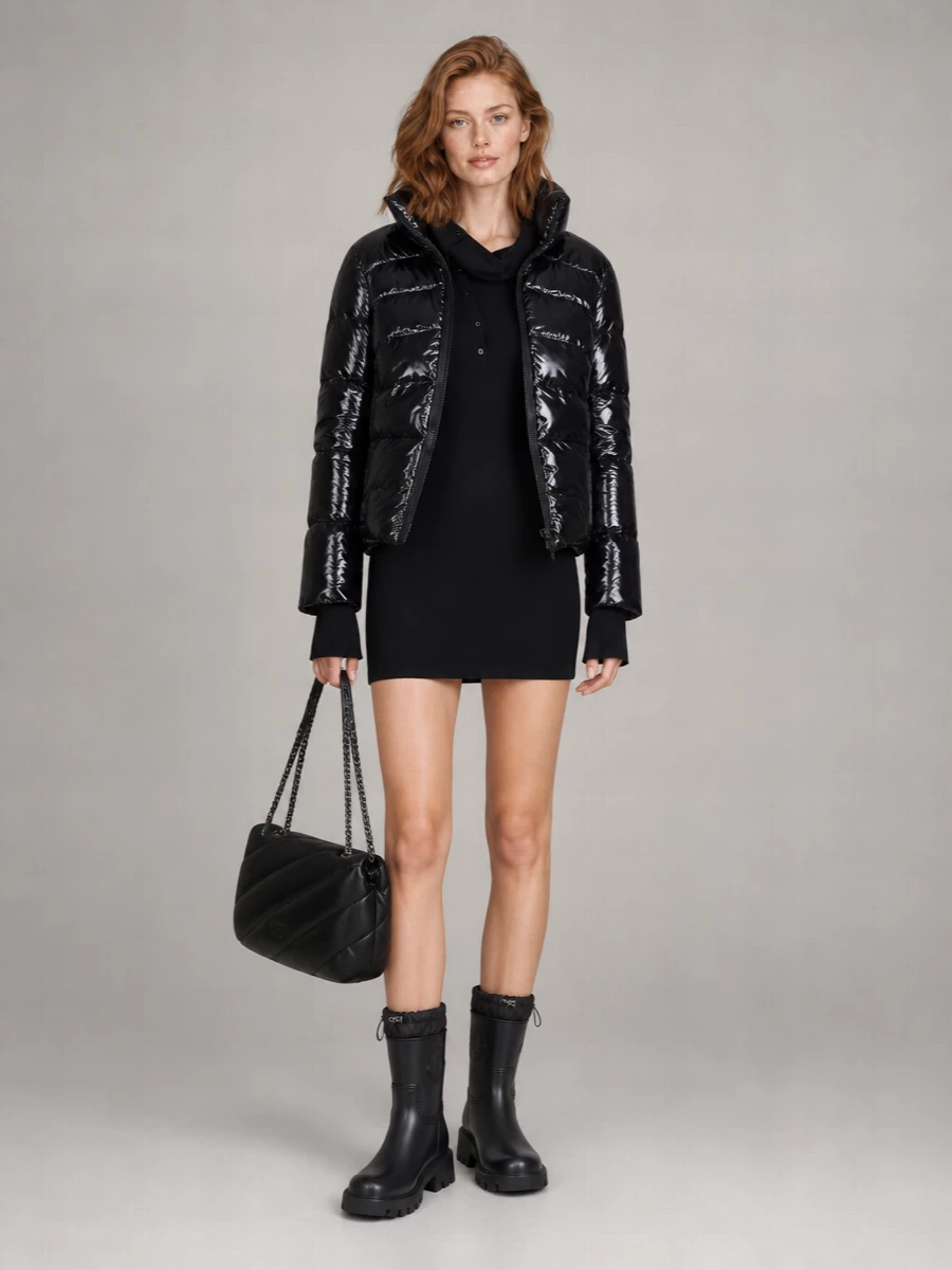 This is a city winter mini built around the glossy Pinko puffer, a hooded knit dress and chunky technical boots, all in deep black. The mix of quilted textures and sporty details feels modern and urban, with the padded shoulder bag echoing the outerwear so the whole outfit reads like one intentional, aprés-ski-meets-street statement. Choosing the dress route keeps the proportions clean and the attitude bolder than a more expected top and trouser pairing would.