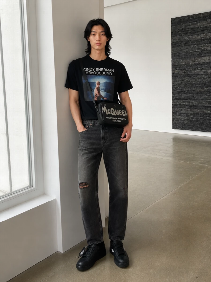 Undercover graphic tee black jeans off white sneakers
