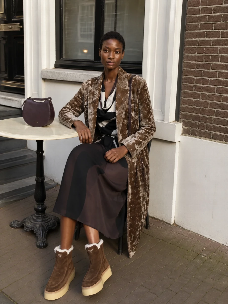 I’m anchoring this with the dress rather than tailoring, letting the Kiton midi read as a fluid, graphic column beneath Uma Wang’s crushed-velvet coat for a romantic winter evening mood. The Prada platform boots keep it grounded and modern, while the compact plum Wandler bag adds just enough color tension to feel intentional, not matchy. The result is statuesque and tactile, with the coat doing the atmospheric work and everything else staying controlled and polished underneath.