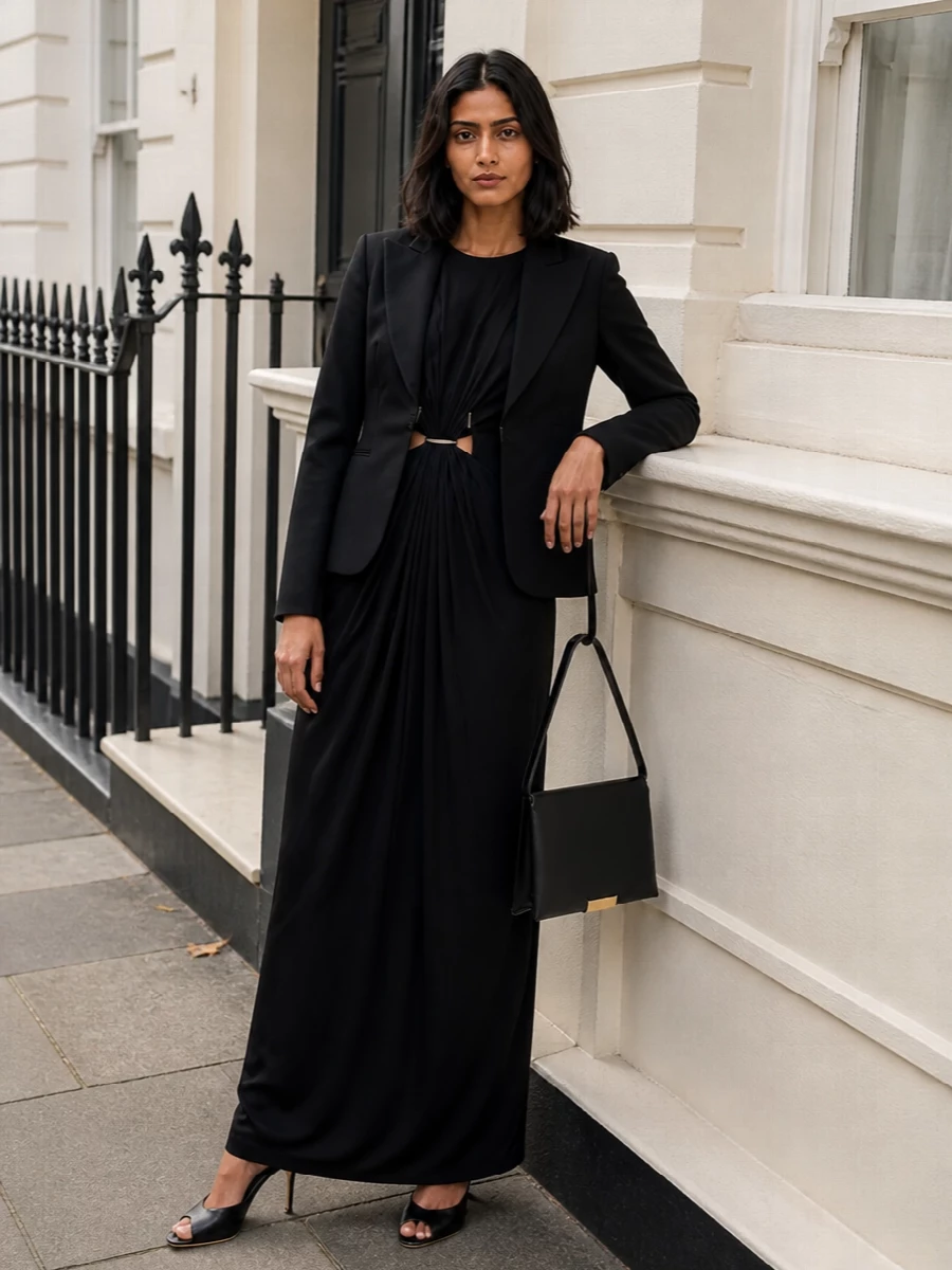 I chose the dress path, using the Gucci blazer as a sharp outer layer over Max Mara’s black column gown for a unified, quietly luxurious evening ensemble. The long, fluid dress balances the blazer’s nipped waist, while the Jimmy Choo heels and Jil Sander bag keep the silhouette clean, elongating and entirely monochrome. It is formal enough for dinners or events yet feels restrained and modern rather than overtly statement-driven.