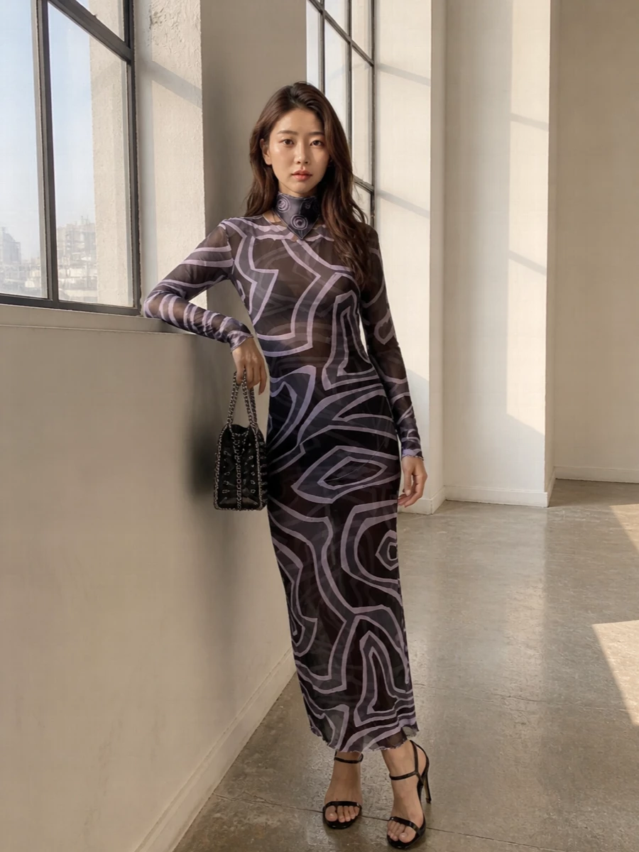 A sheer Pucci maxi does all the talking here, its lilac-on-charcoal pattern running uninterrupted from neckline to hem. Strappy black stiletto sandals keep the energy firmly after dark, while the eyelet chain bag adds metallic attitude without competing with the print. A matching Pucci scarf is your final nod to the motif, whether knotted at the neck or in the hair for a graphic finish.