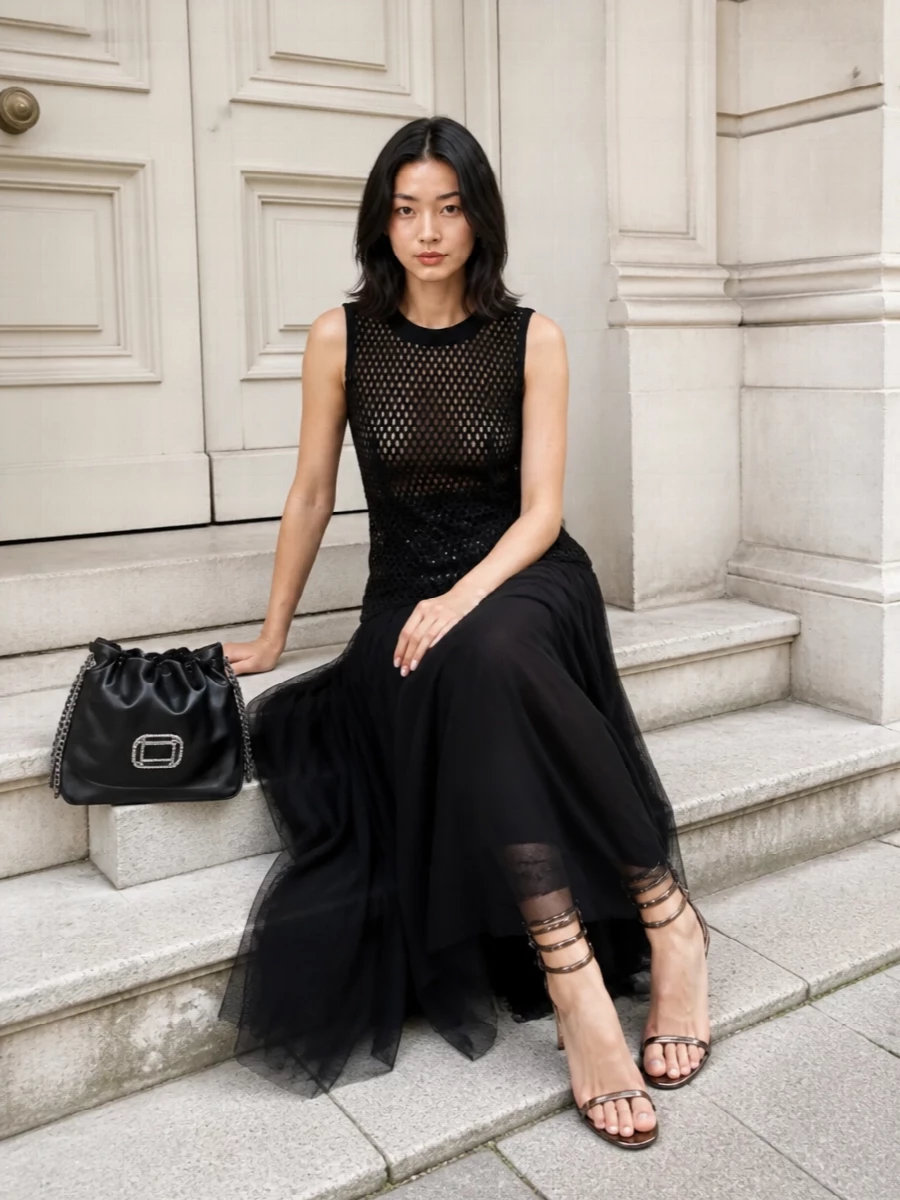 This is pure nocturnal glamour: the sheer sequined maxi clings and flickers over the body, letting the tortoiseshell spiral sandals coil up the leg like jewelry. The black crystal‑buckle clutch adds a compact flash of light at the hand, keeping everything in a tight, moody palette of black and warm brown for a very modern y2k‑inflected evening moment. I chose the dress path rather than separates to let the sandals’ sculptural line run clean and uninterrupted, turning the entire ensemble into one long, liquid column from ankle to shoulder.