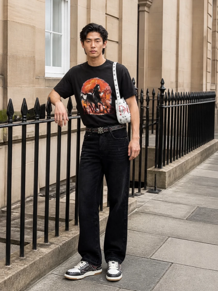 Amiri graphic tee black jeans studded sneakers
