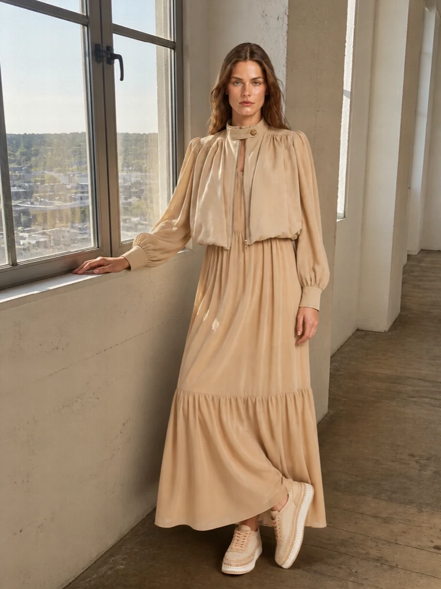 I’m building around the jacket’s sculpted volume, so a dress is the stronger anchor than separates here. The sand tiered maxi extends that soft architecture into a long, tonal column, while the artisanal sneaker keeps it city-ready and the structured satchel brings just enough definition. The result is romantic Chloé neutrals for daytime events, with ease from head to toe but a very considered silhouette.