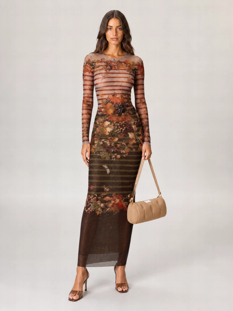 A full Gaultier mesh column in coordinated grape-and-vine florals turns the body into a softly painted silhouette, romantic but with that sly, subversive edge. Espresso-transparent heels and a padded neutral baguette keep the palette grounded and modern, letting the print carry the drama. It is an easy go-to for gallery nights or late dinners when you want something sensual yet intelligent.